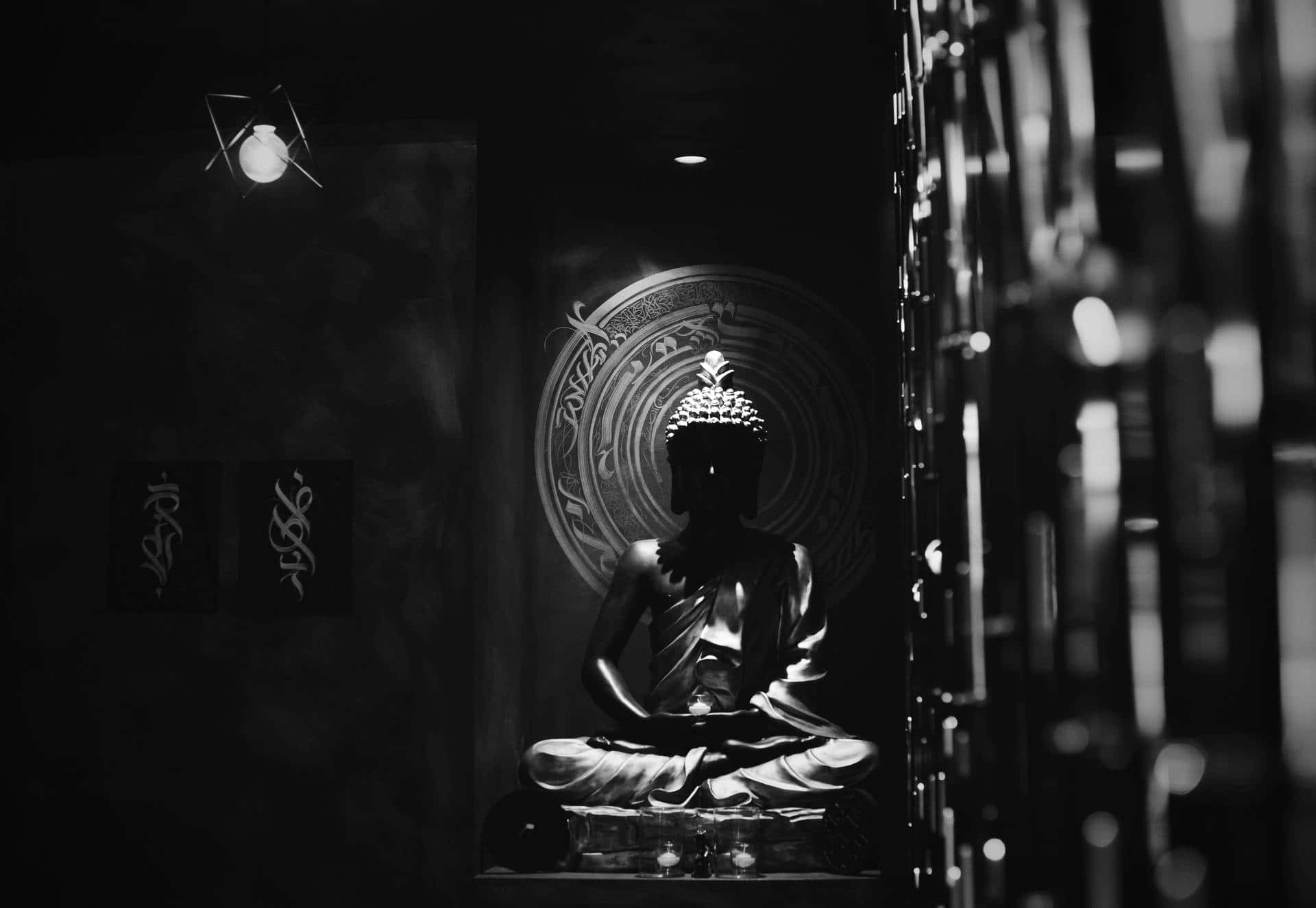 A Black And White Photo Of A Buddha Statue