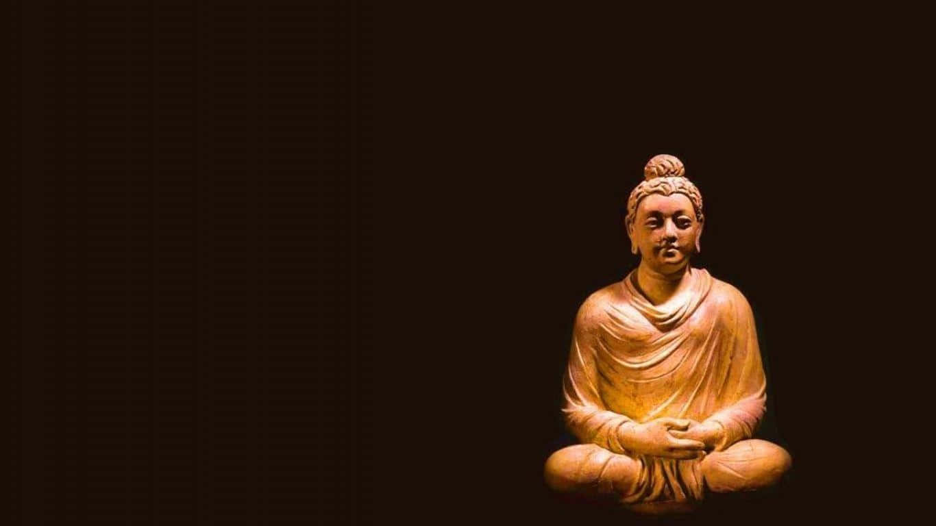 Einebuddha-statue Sitzt Auf Einem Schwarzen Hintergrund.