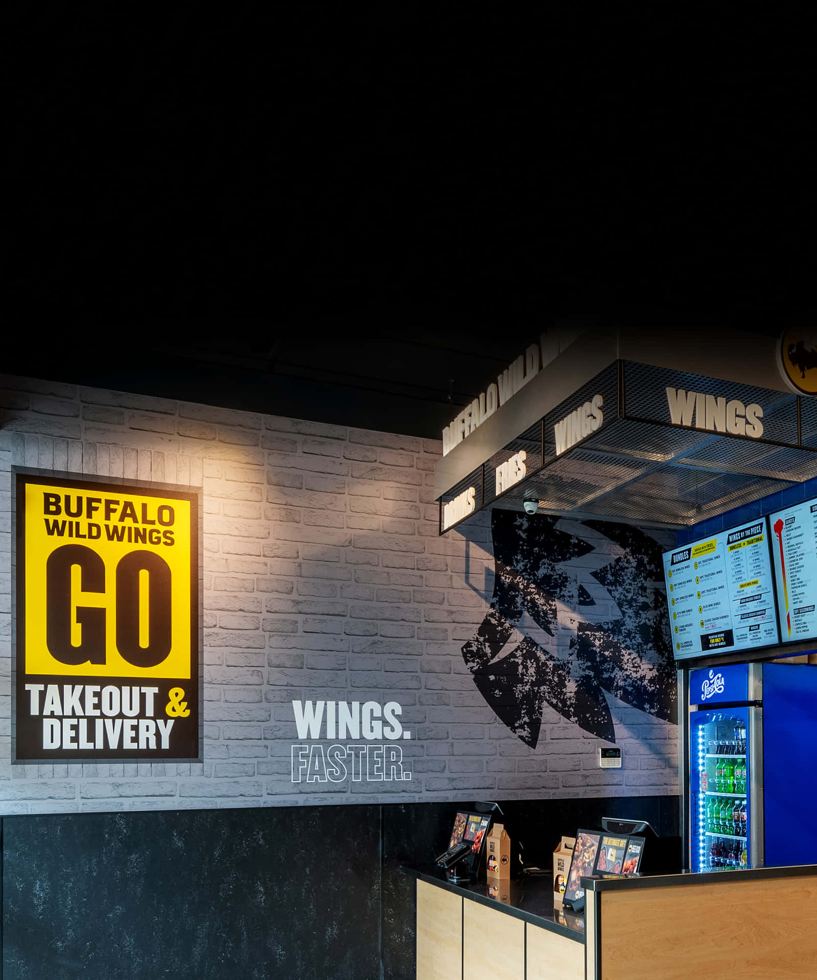 Buffalo Wild Wings Glowing Signage Against Night Sky