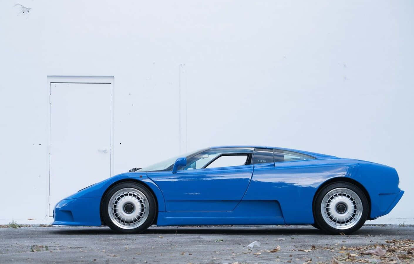 Bugatti EB110 Speeding on the Road Wallpaper