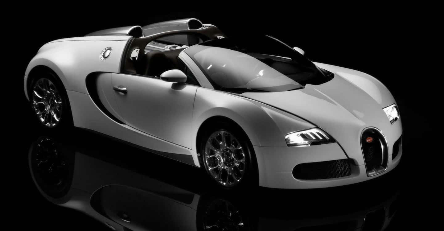 A sleek Bugatti Veyron in motion on an open road Wallpaper