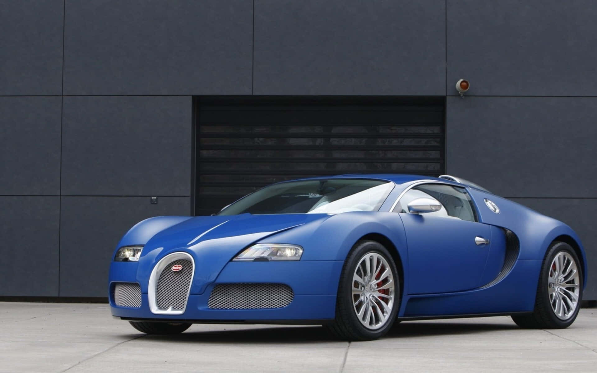 Sleek Bugatti Veyron in a Night City Setting Wallpaper