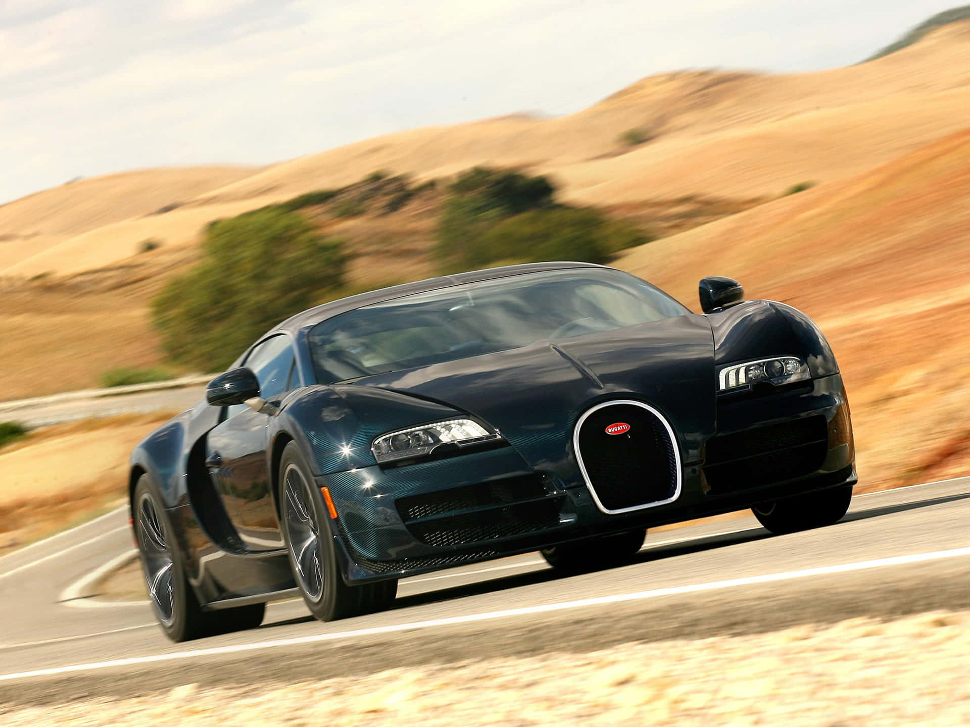 Sleek Bugatti Veyron Cruising the Open Road Wallpaper