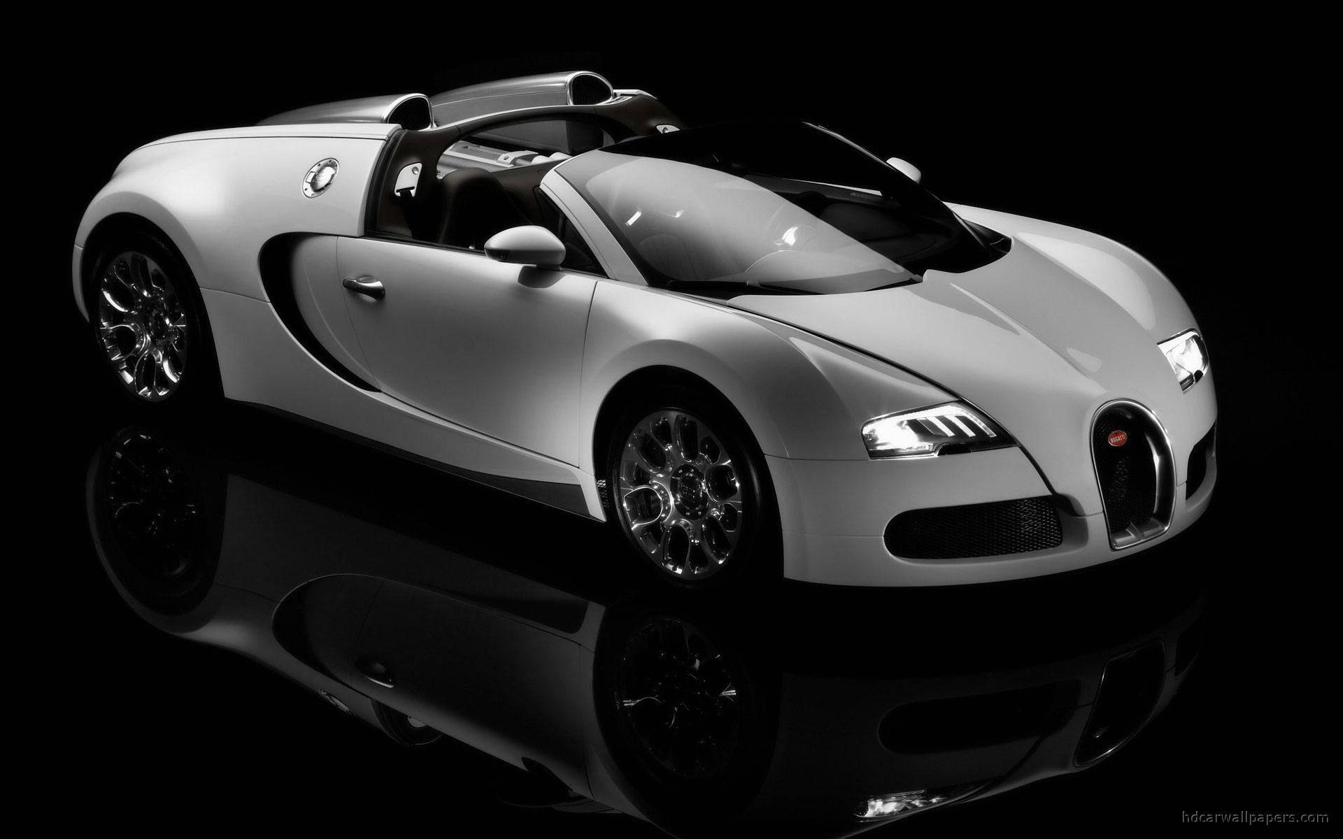 Shiny White Bugatti Car Wallpaper — A sleek silver Bugatti Veyron supercar gleams under studio lights on a reflective black surface.