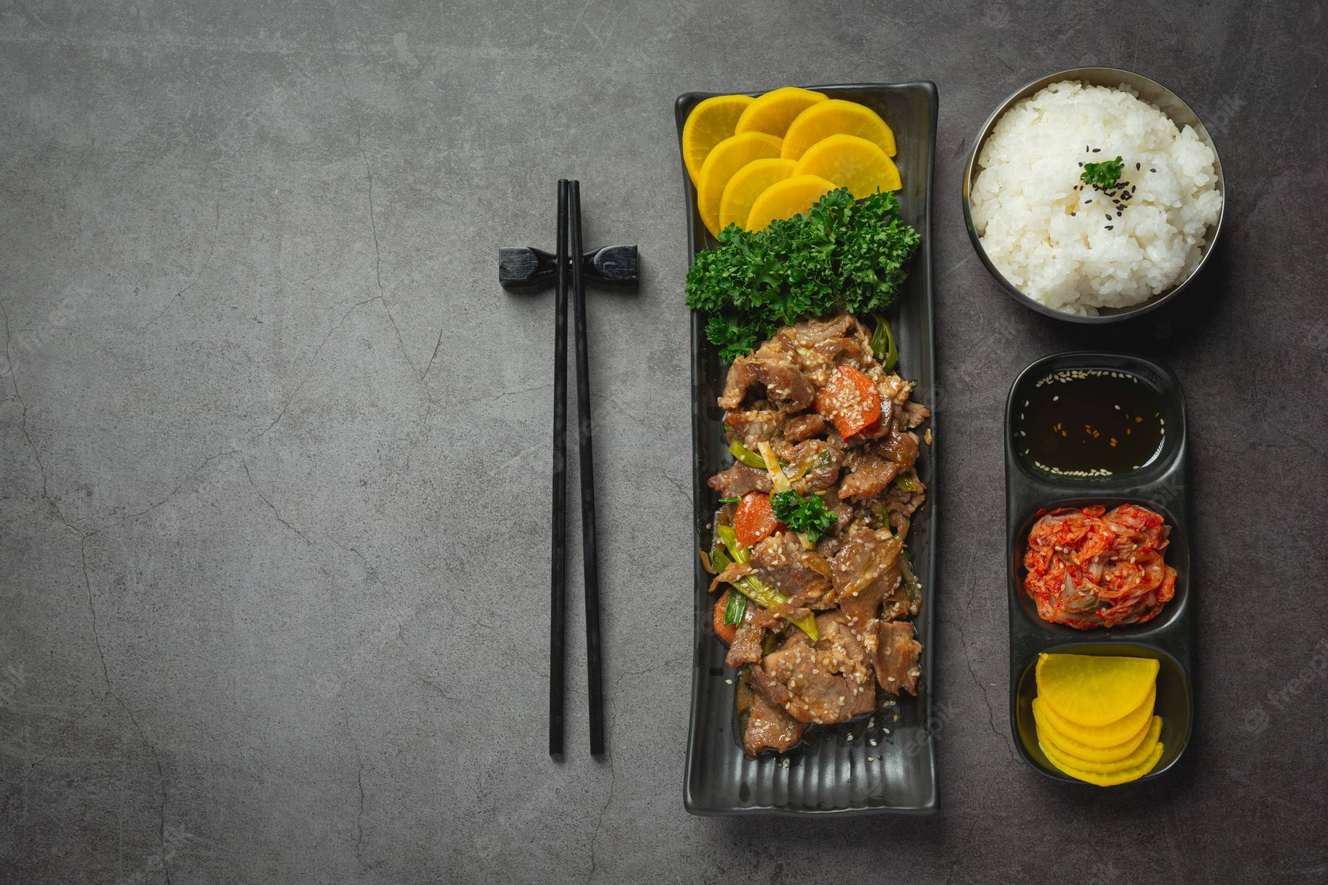 Delectable Bulgogi Dish with Sides and Chopsticks Wallpaper