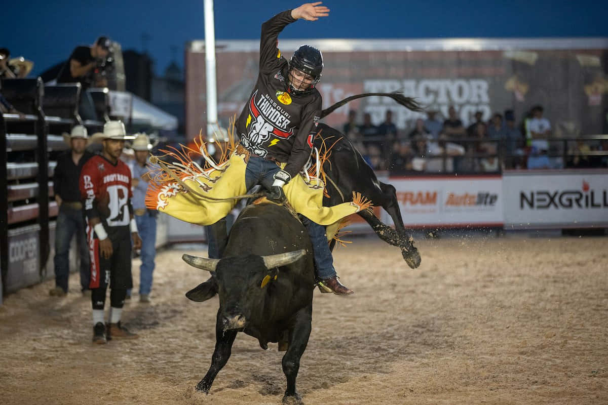 Download Bull Riding Actionat Rodeo Wallpaper | Wallpapers.com