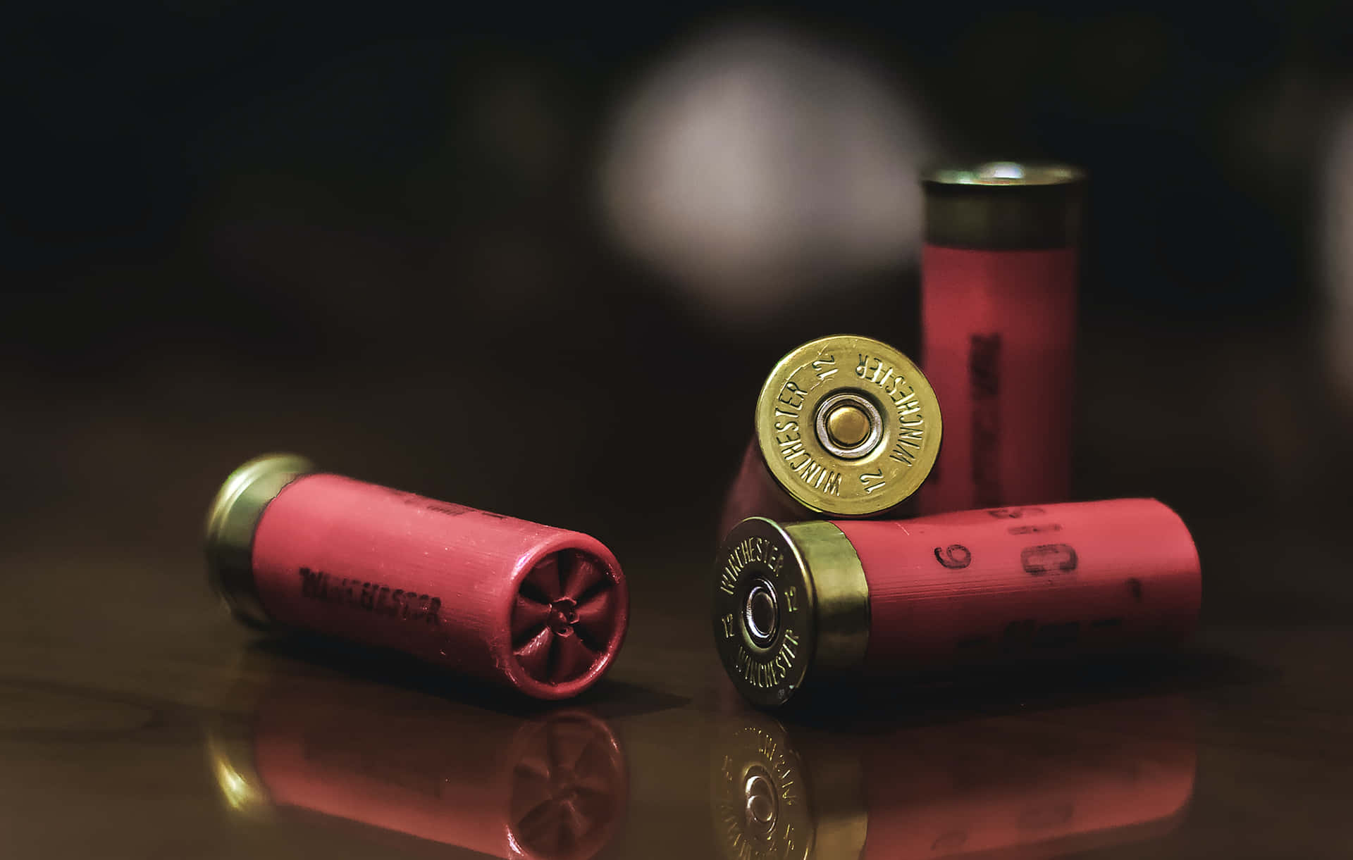 A Group Of Red Shotgun Shells On A Table