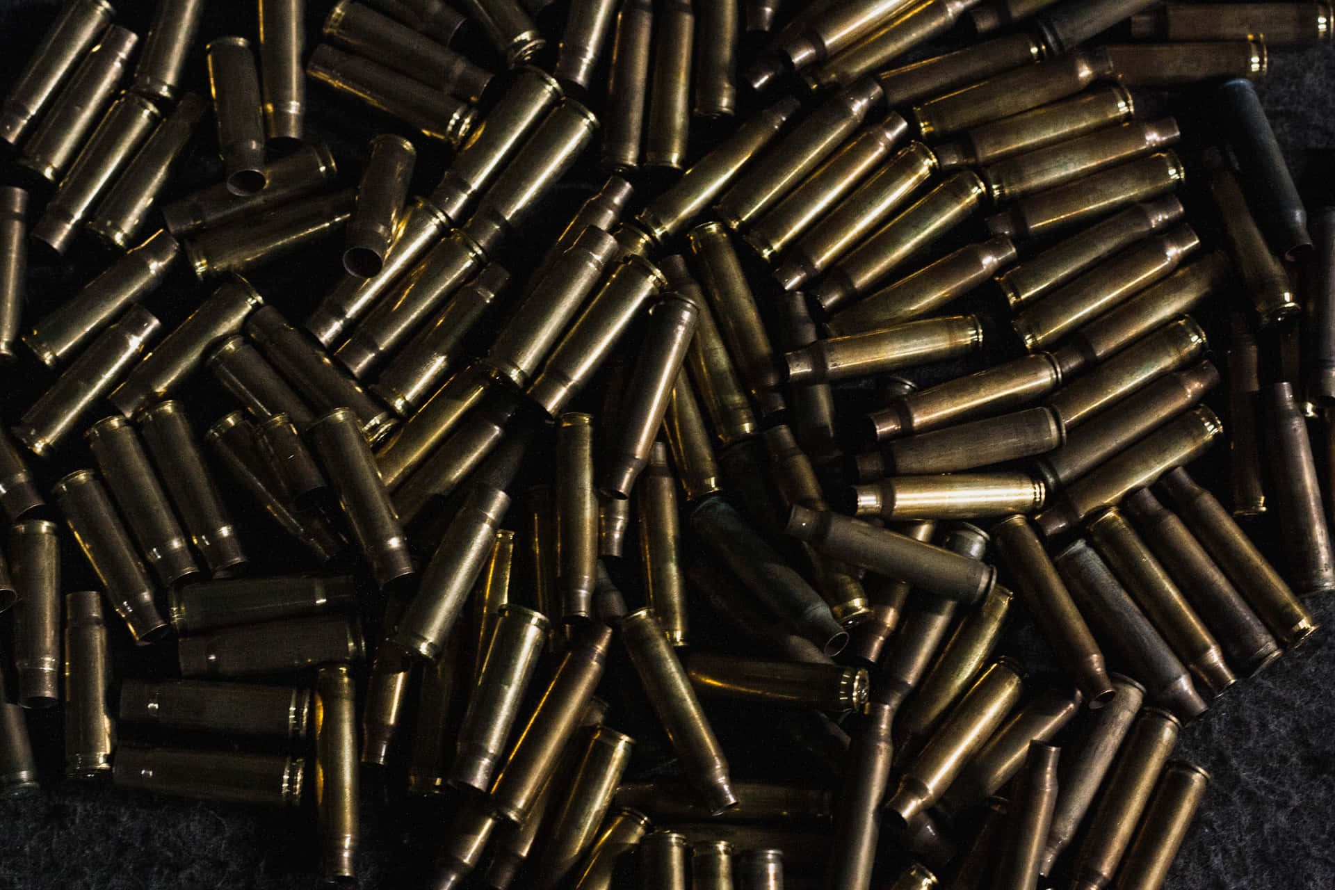 A Pile Of Bullets On A Black Surface