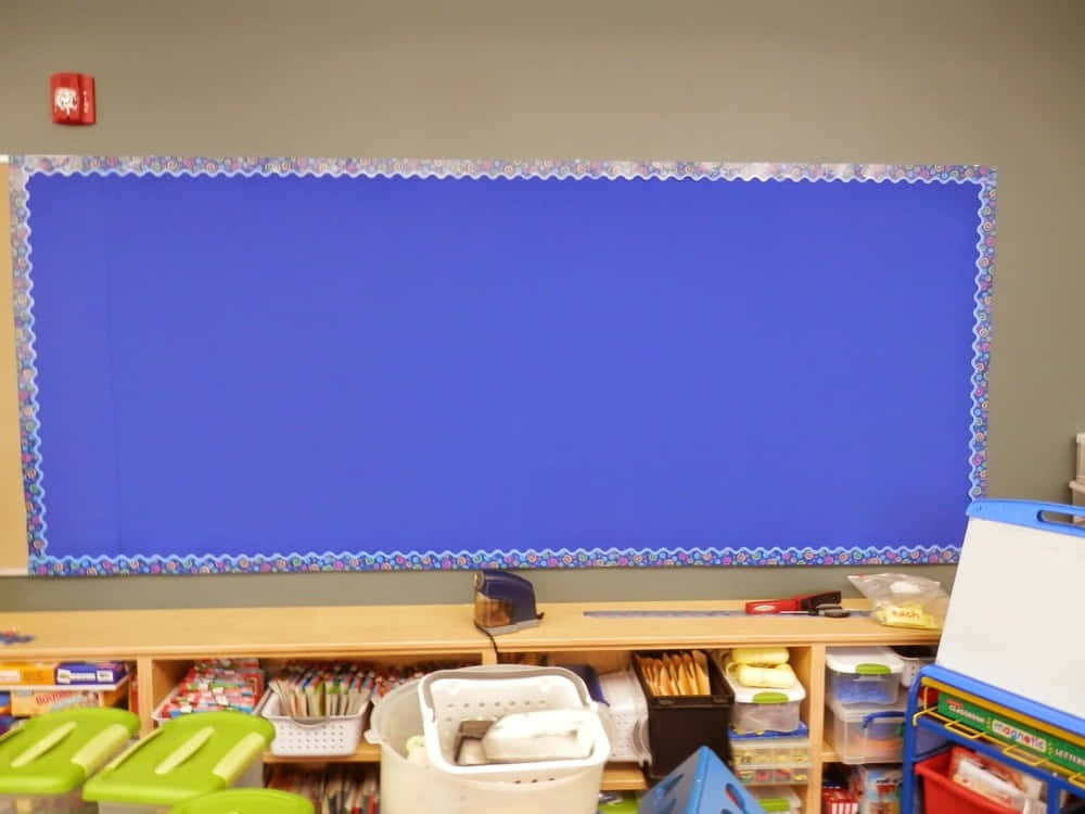 A Blue Bulletin Board With A Lot Of Supplies
