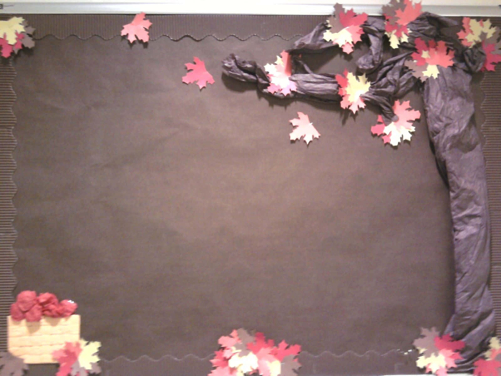 A Brown Bulletin Board With A Tree And Leaves