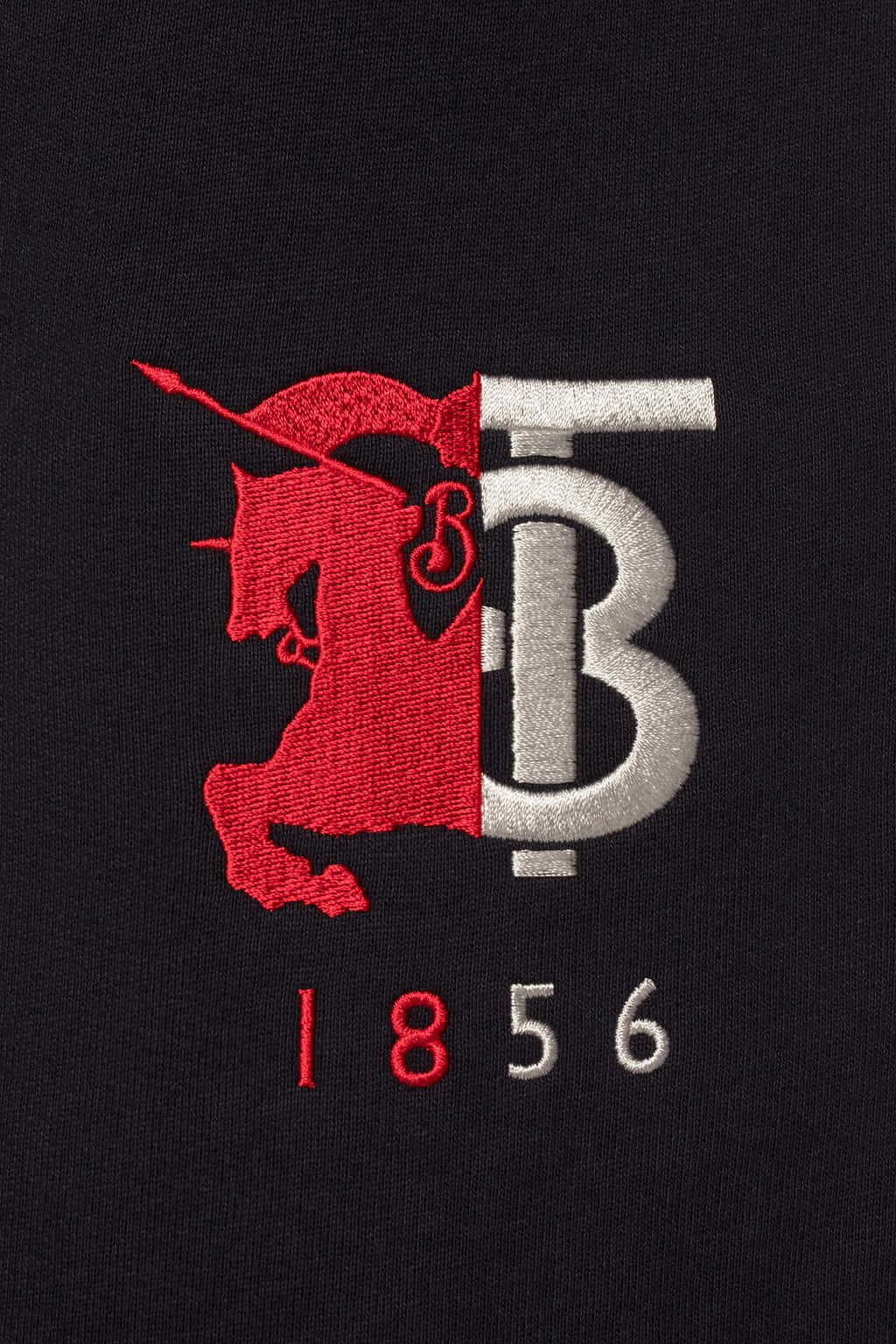 a black t - shirt with a red and white logo