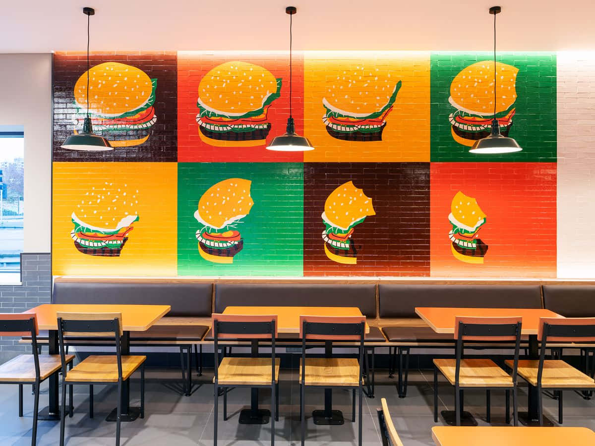 A Restaurant With A Colorful Mural On The Wall