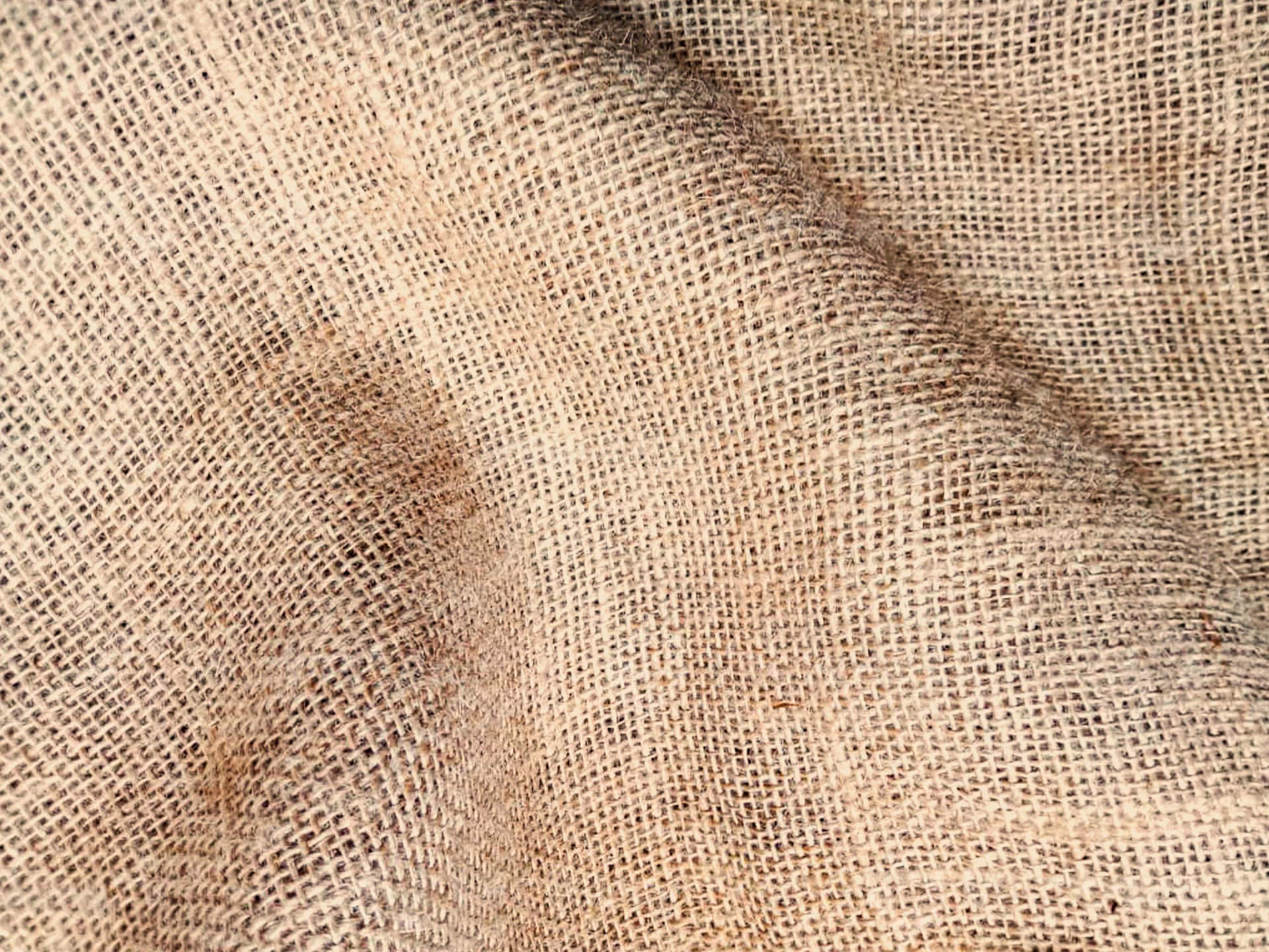Burlap fabric background with an aged, weathered look