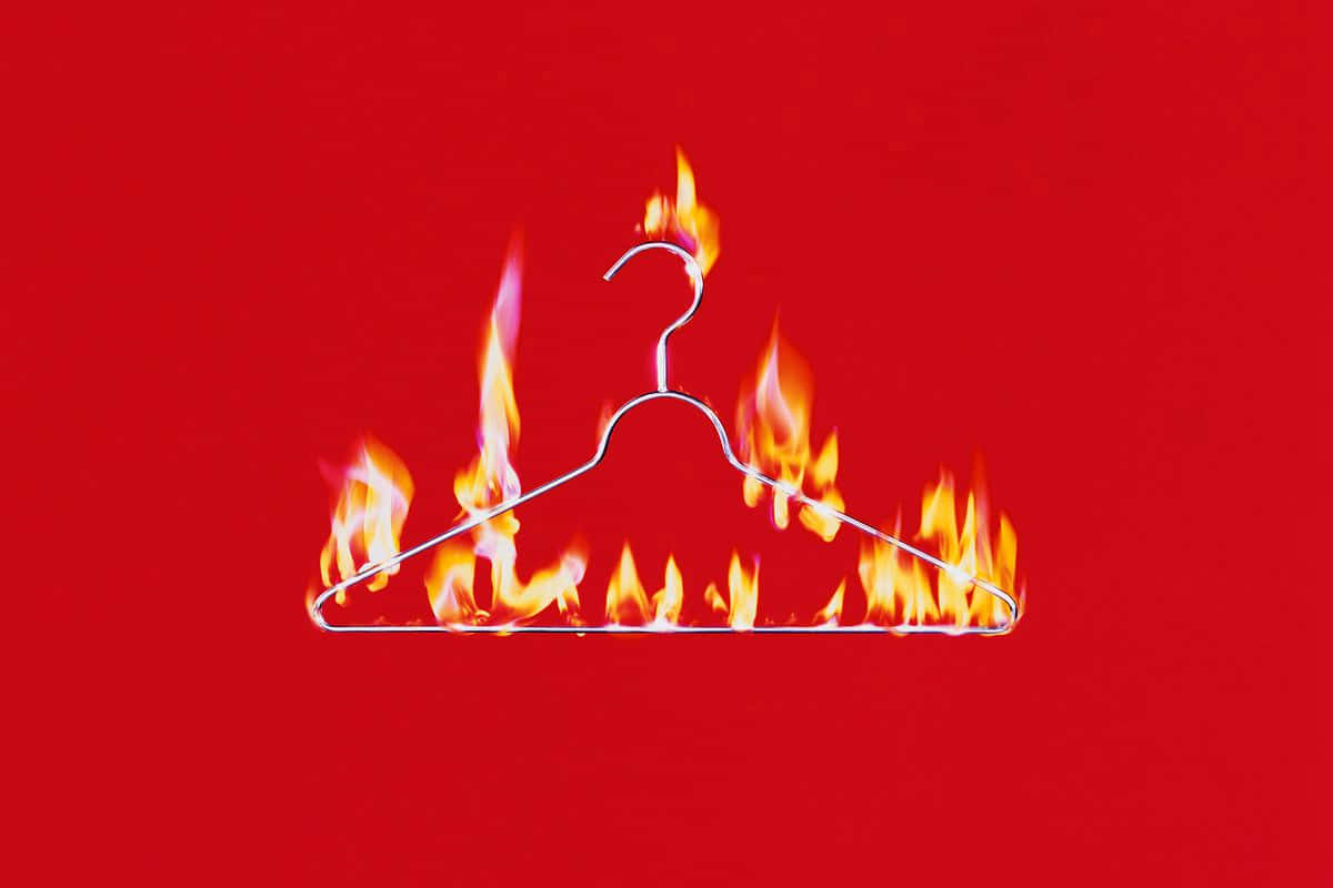 A Red Background With A Fire Hanging On A Hanger