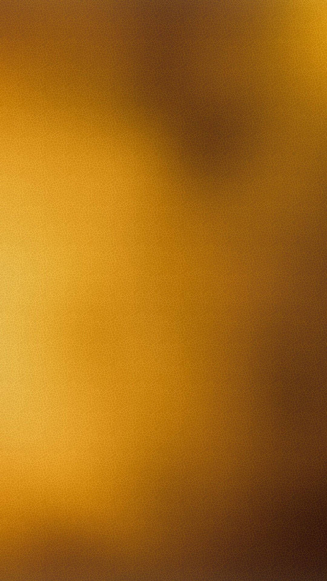 Verbrannteseinfarbiges Goldhintergrundbild. Wallpaper