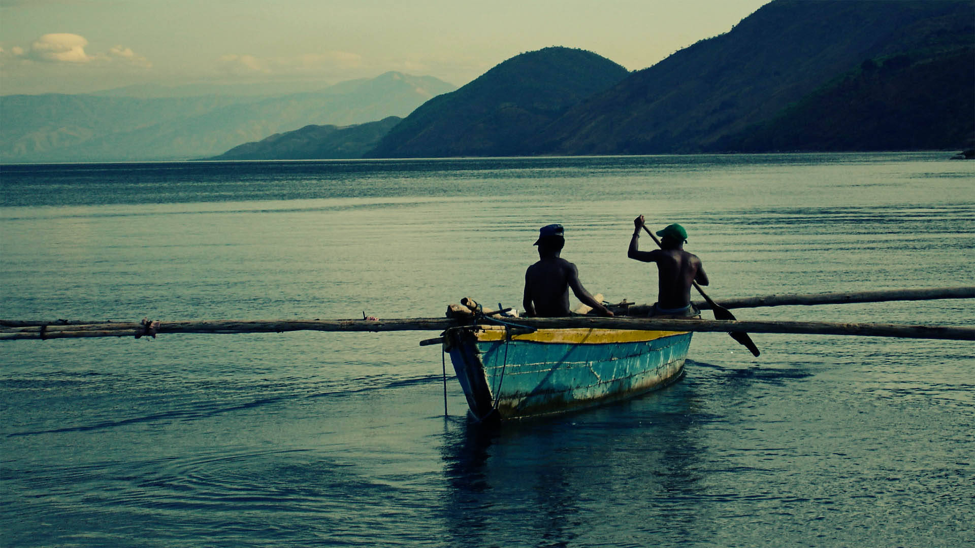 Burundi Men Paddling A Boat