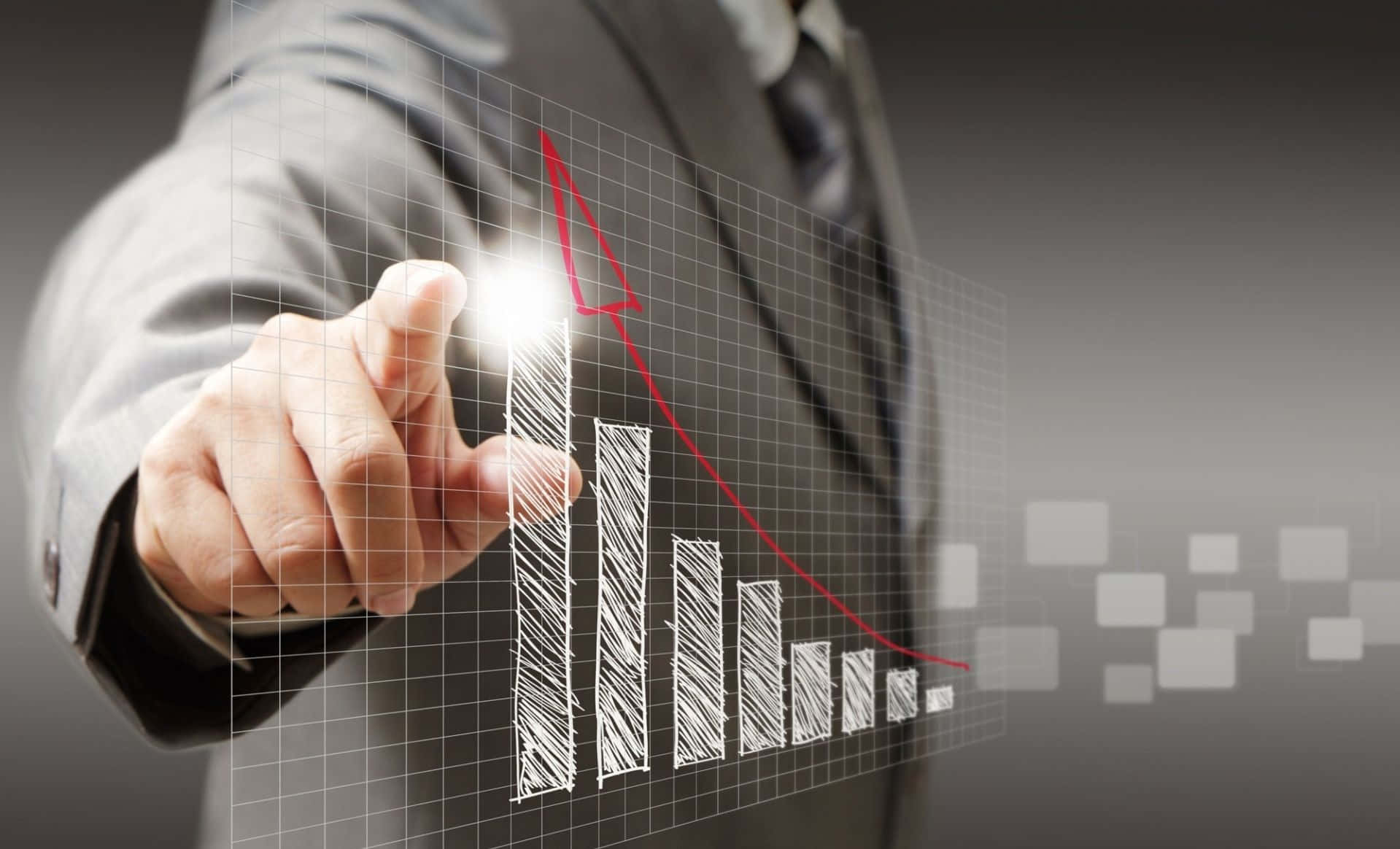 A Businessman Is Pointing At A Graph