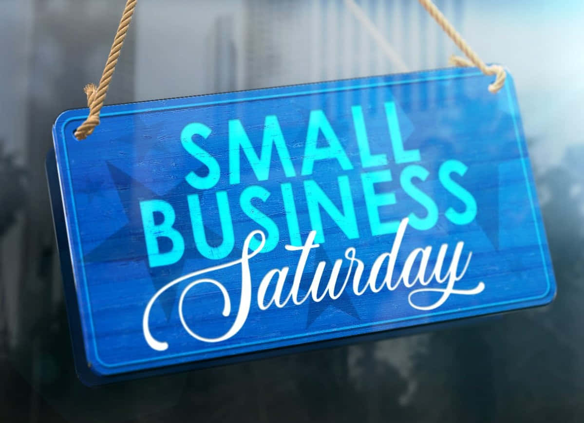 Small Business Saturday Sign Hanging From A Window