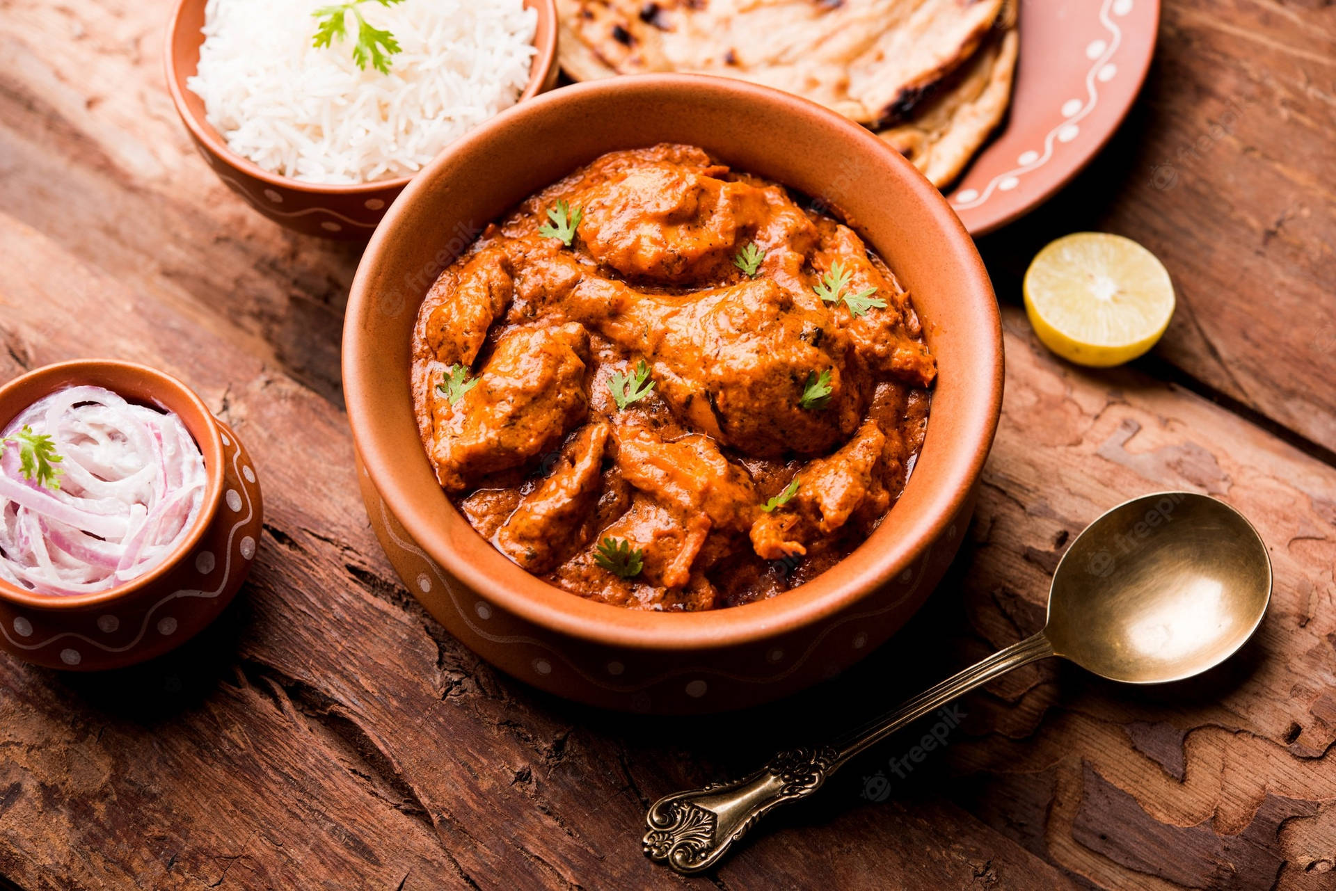 "Sumptuous Butter Chicken Curry in Traditional Indian Clay Pot" Wallpaper