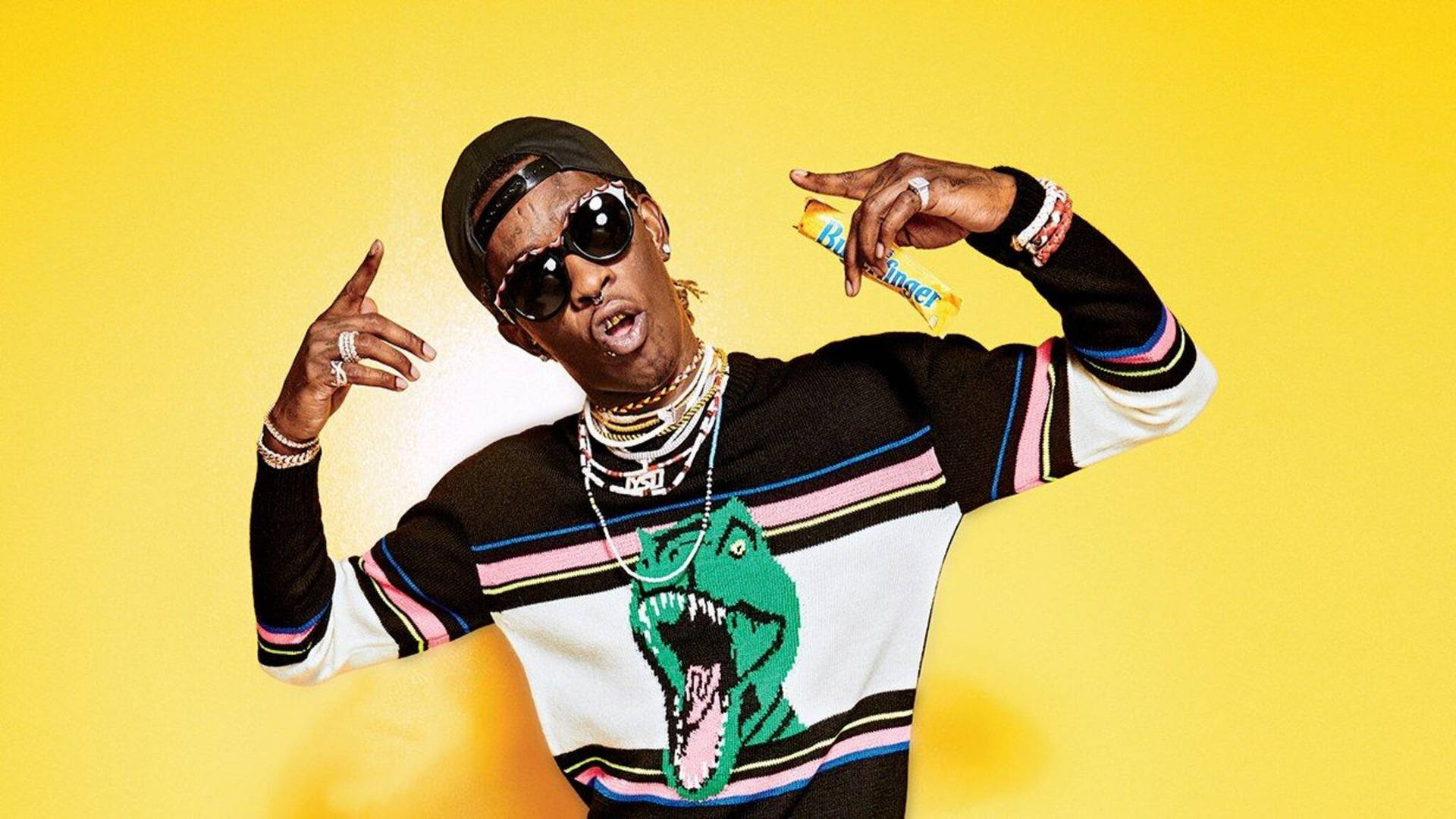 Young Thug holds a Butterfinger candy bar in his hand Wallpaper