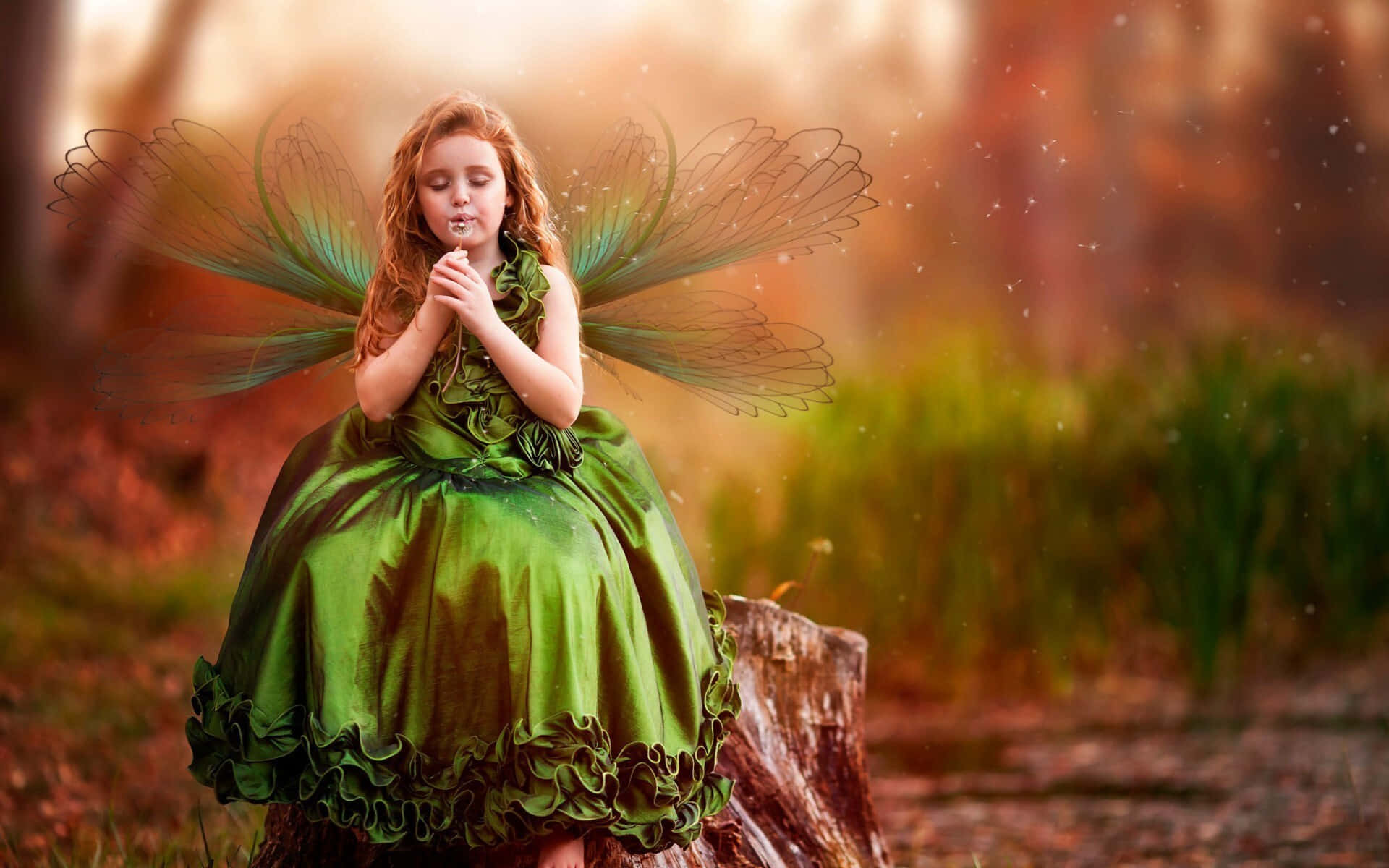 A young woman wearing a shimmering butterfly dress sparkles in the light. Wallpaper