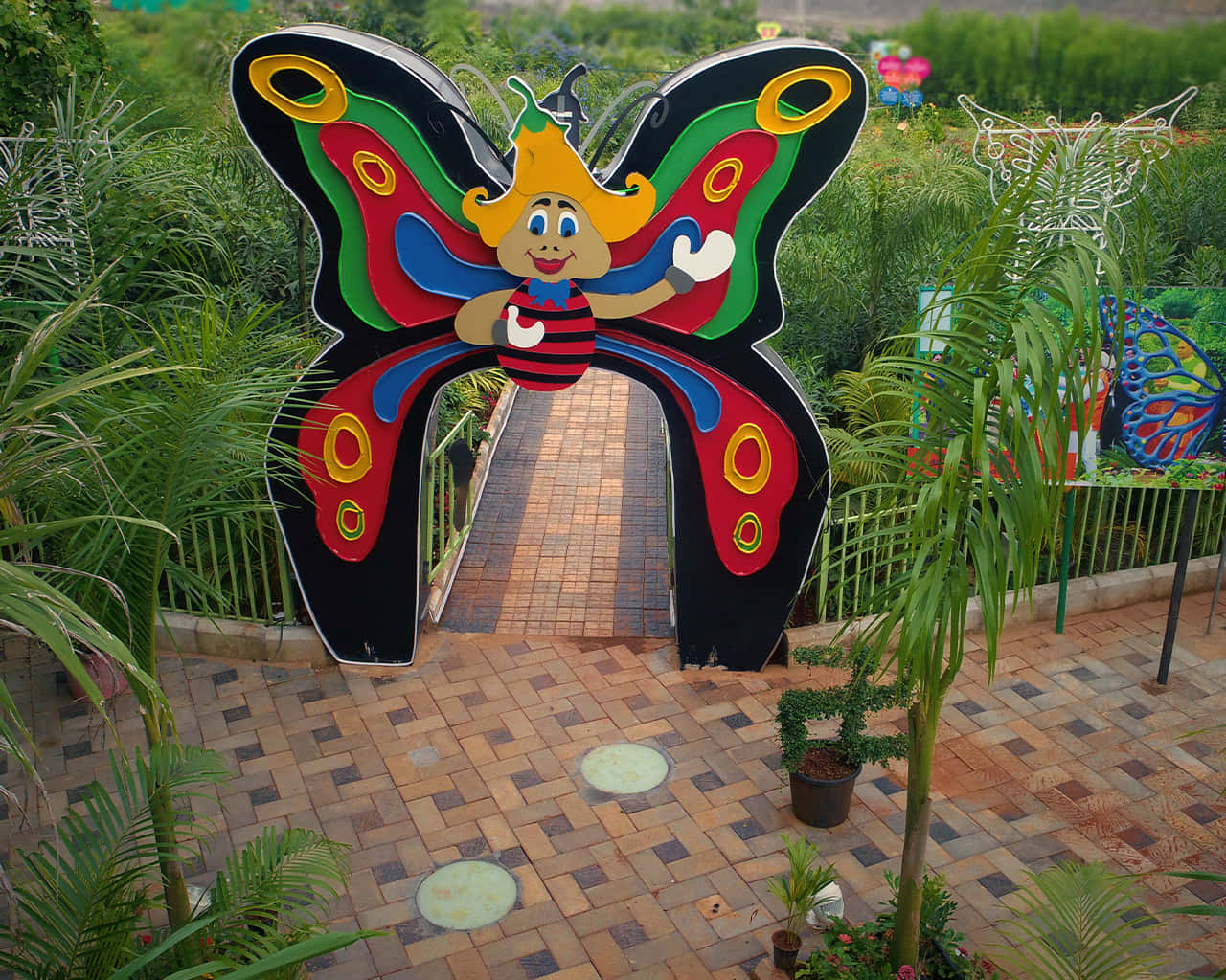 Enjoy the tranquil beauty of nature in Butterfly Park Wallpaper