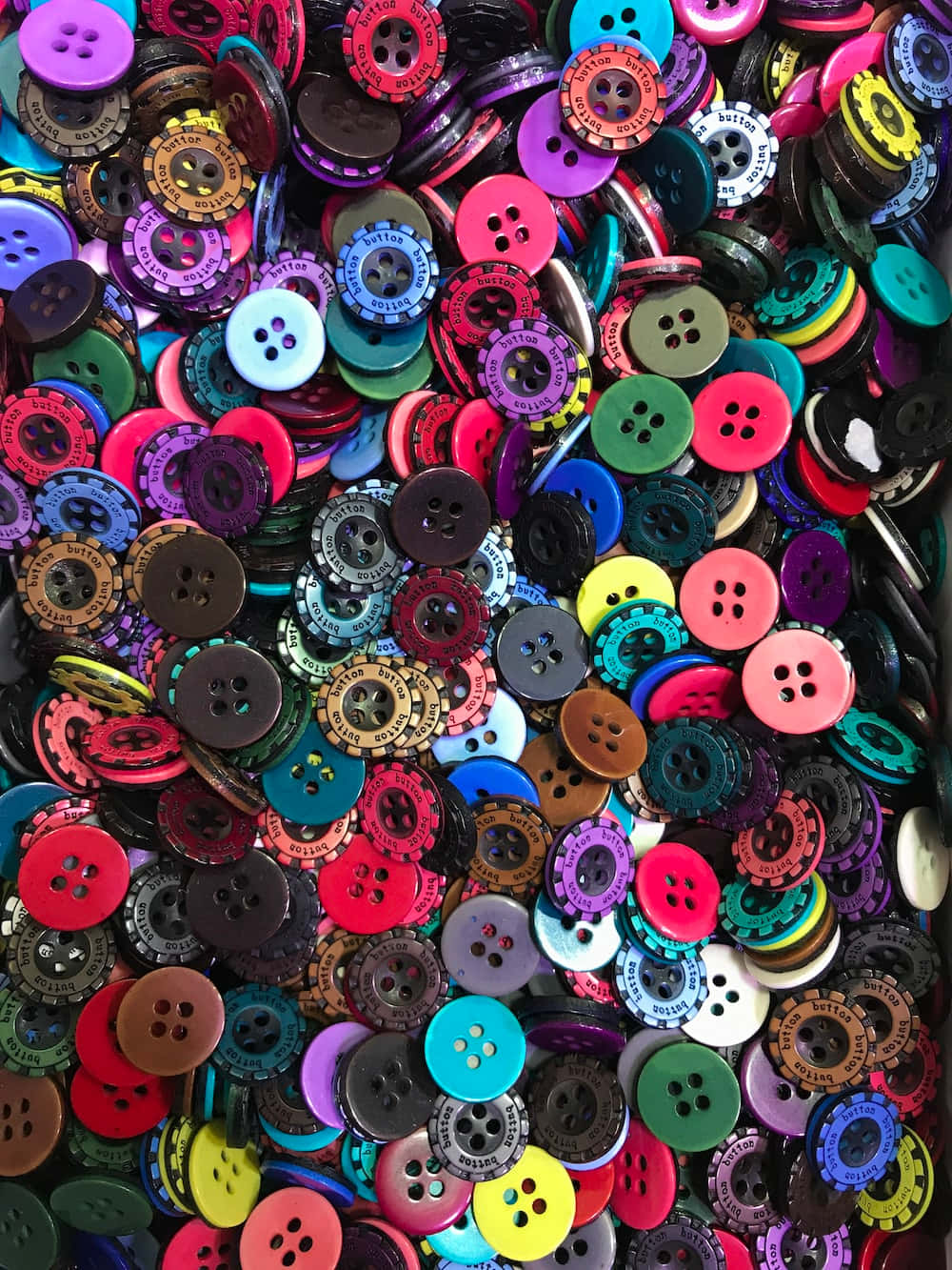 A Pile Of Colorful Buttons In A Box