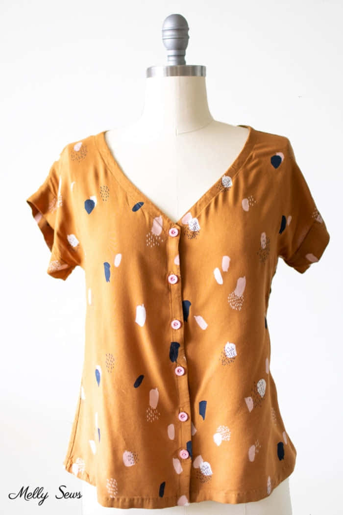 A Mustard Colored Blouse With A Pattern Of Dots
