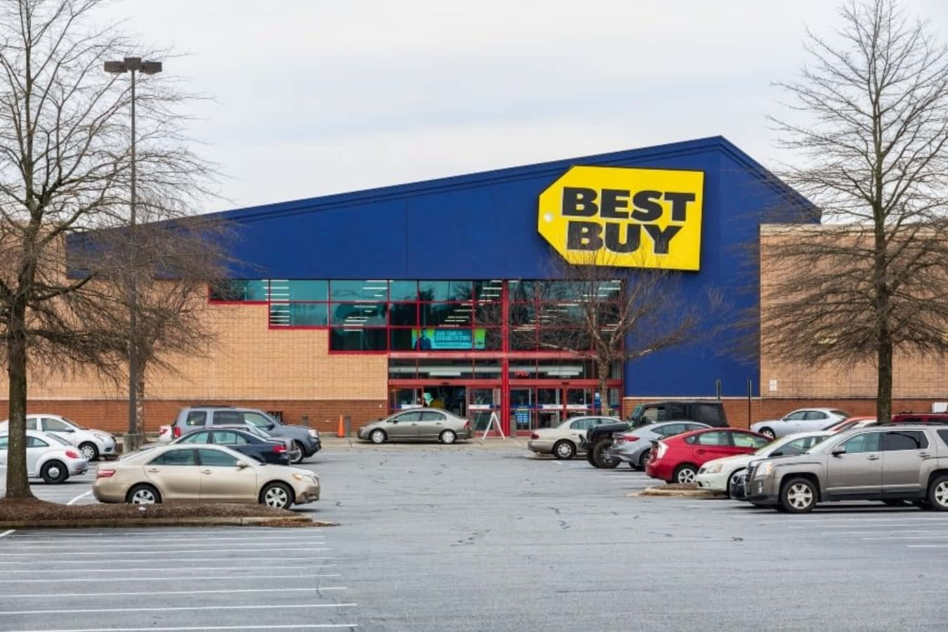 Best Buy Is A Large Store With Cars Parked In Front