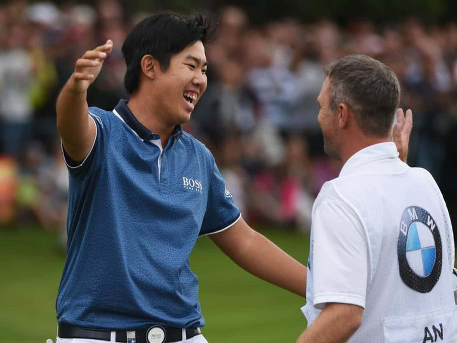 Byeong Hun An And His Caddie Celebrating Victory Background