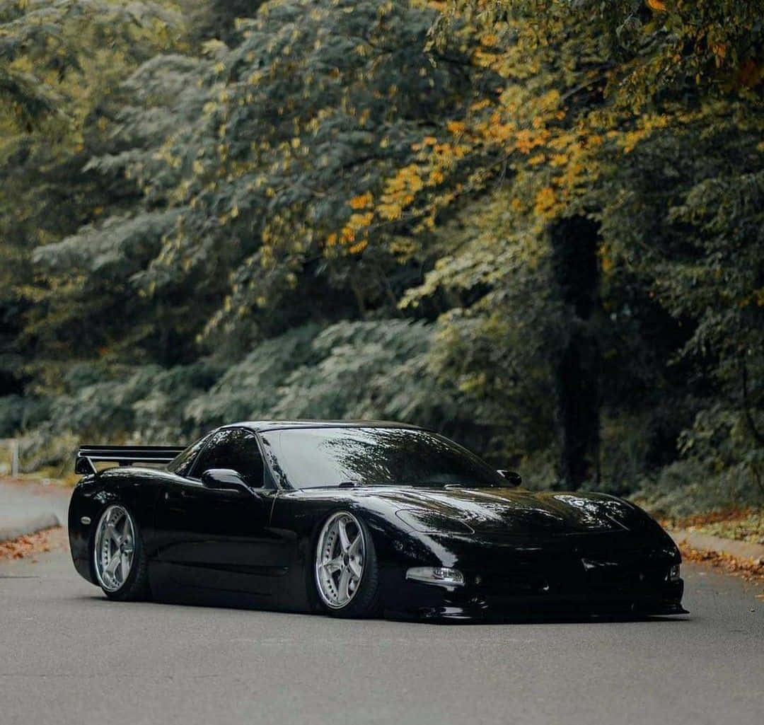 A Black Sports Car Parked On A Road