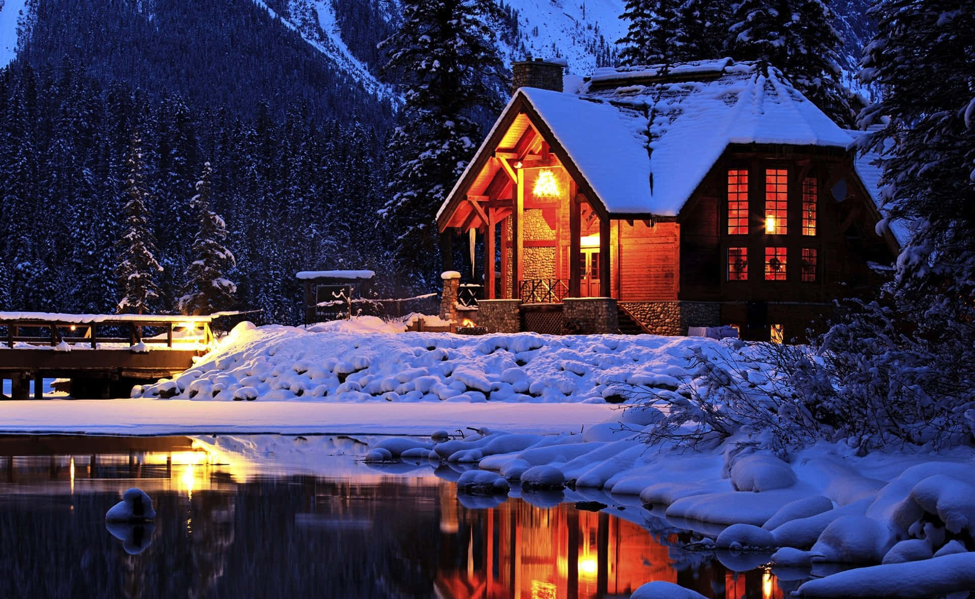 Cabin Covered In Snow At Night Wallpaper