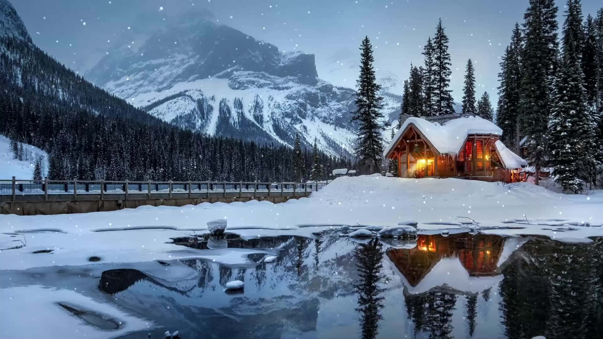 Cabin Covered In Snow By A Lake Wallpaper