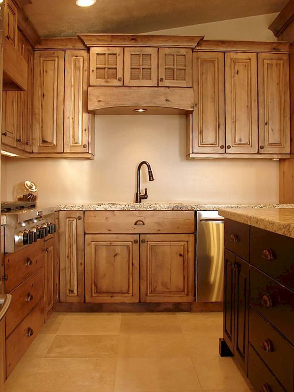 A Kitchen With Wooden Cabinets And Granite Counter Tops