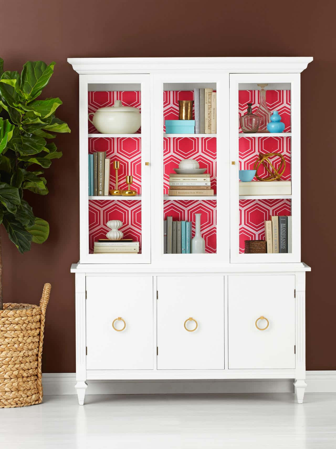 A White China Cabinet With Pink Wallpaper