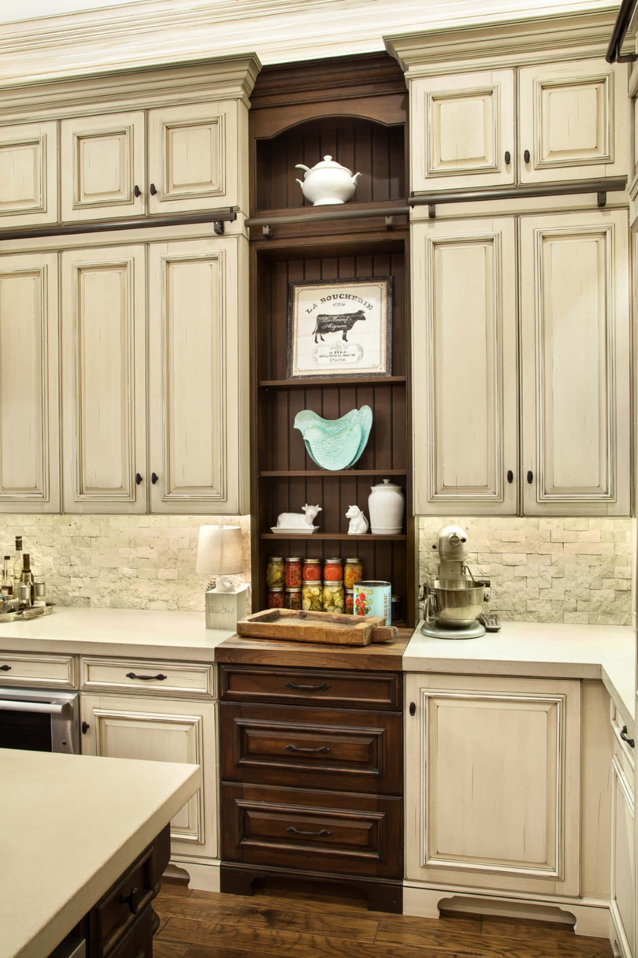 A Kitchen With White Cabinets And A Wooden Counter Top