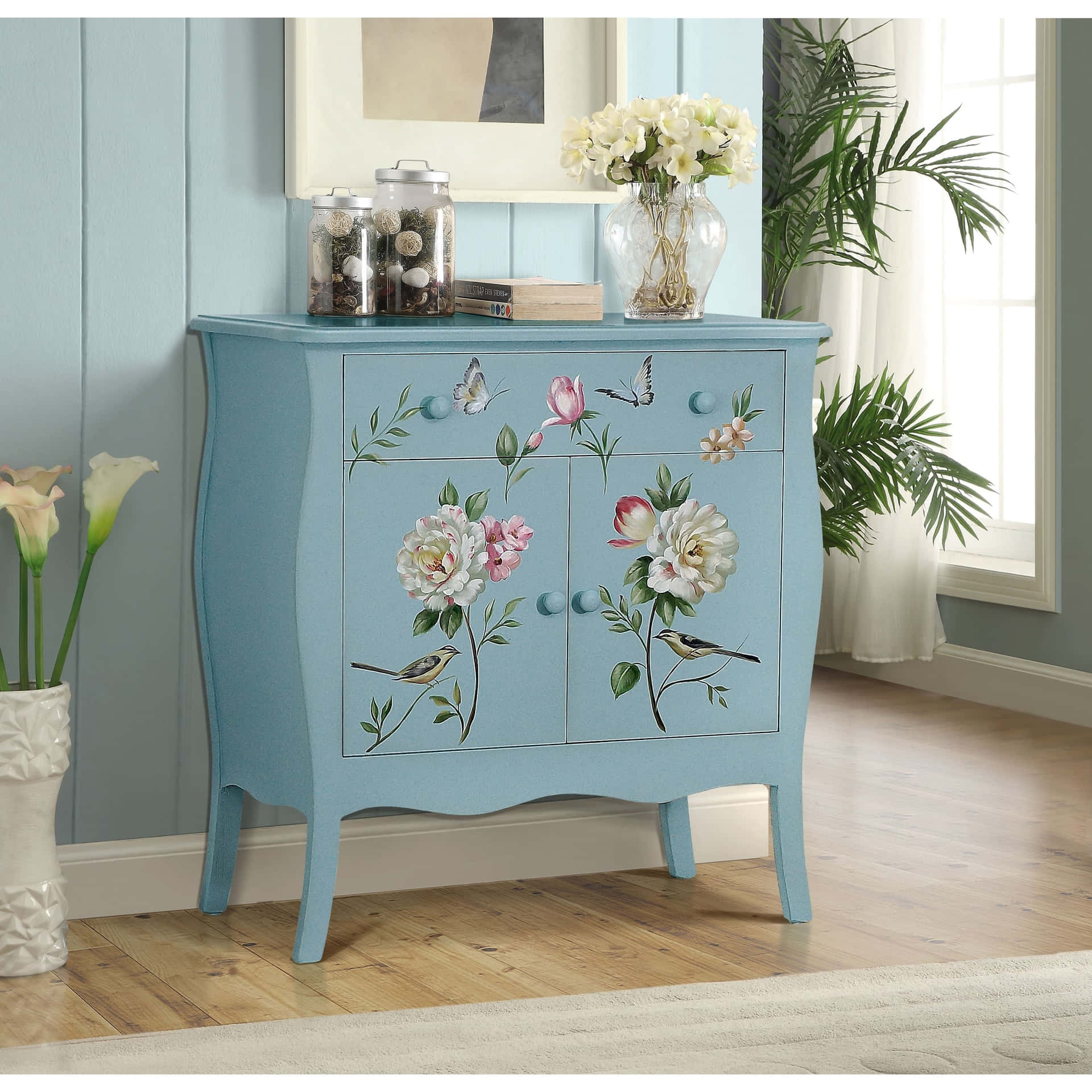 A Blue Painted Cabinet With Flowers On It
