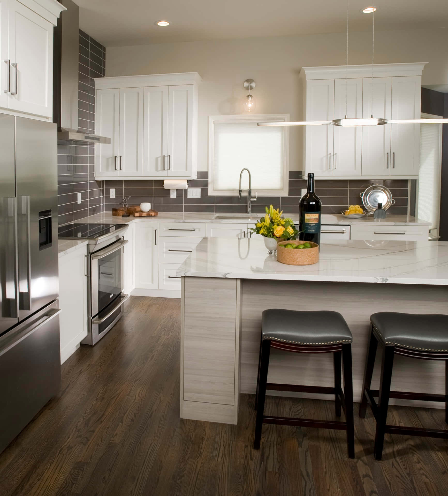 A Kitchen With White Cabinets And A Bar Stools