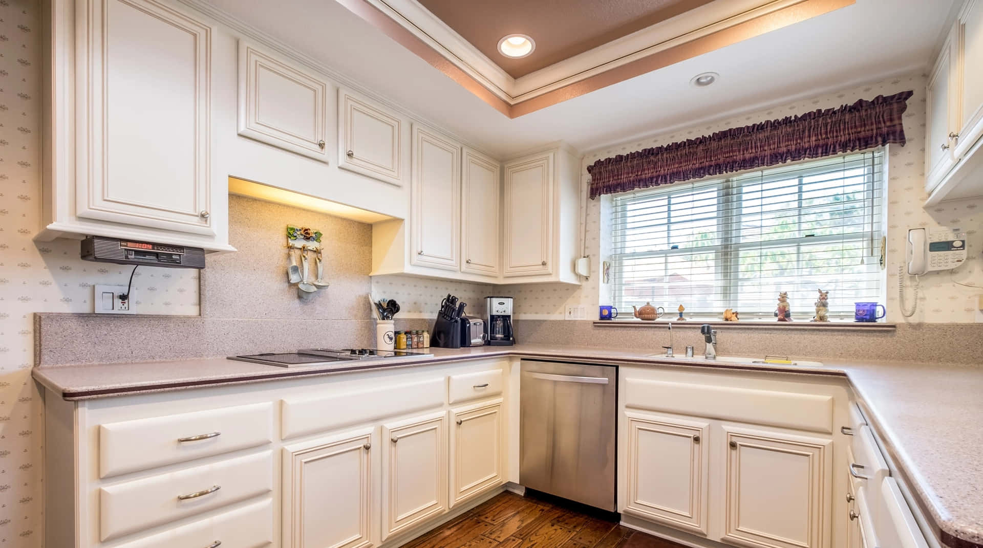 A Kitchen With White Cabinets And A Sink