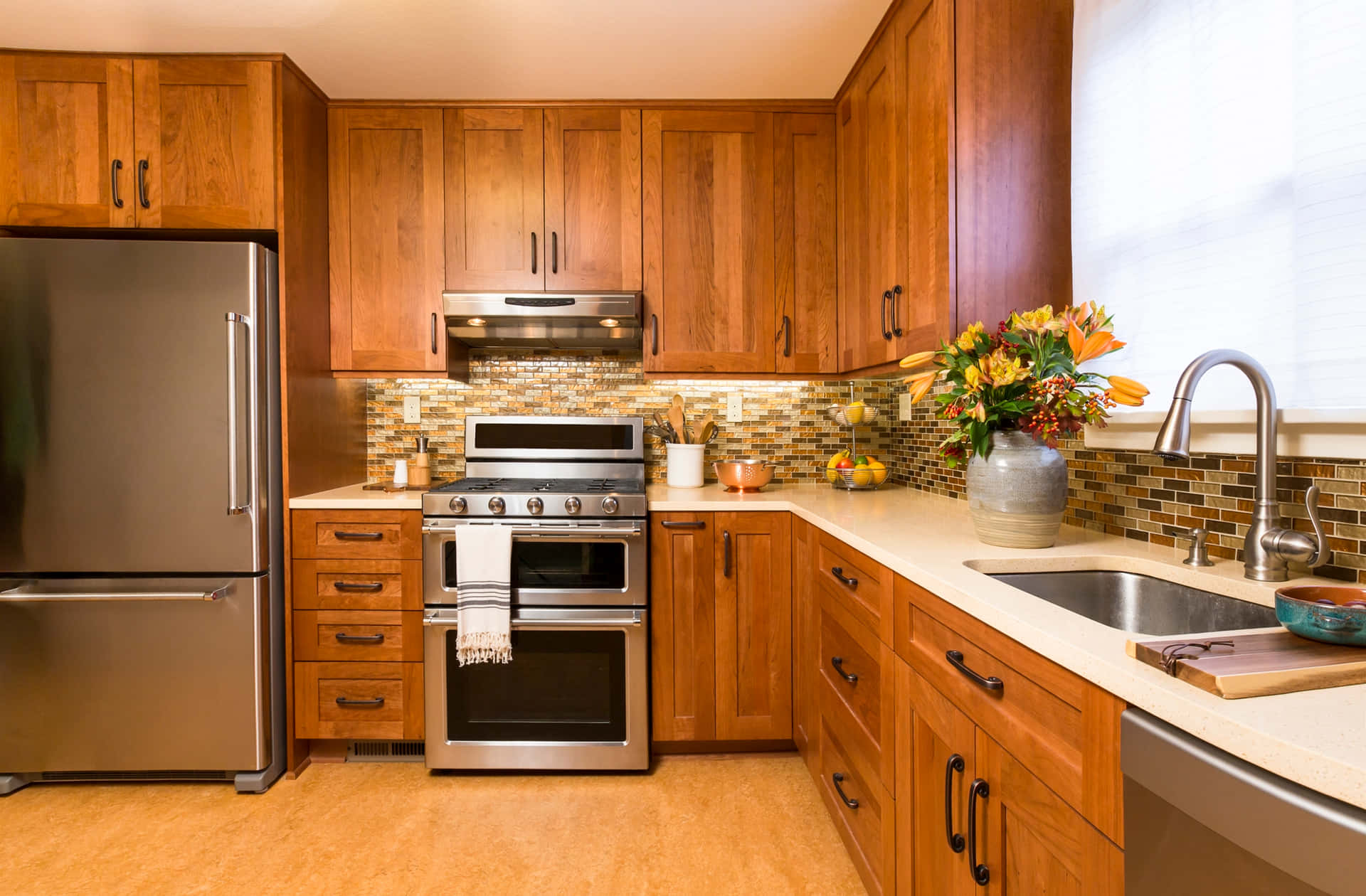 A Kitchen With Wood Cabinets And Stainless Steel Appliances
