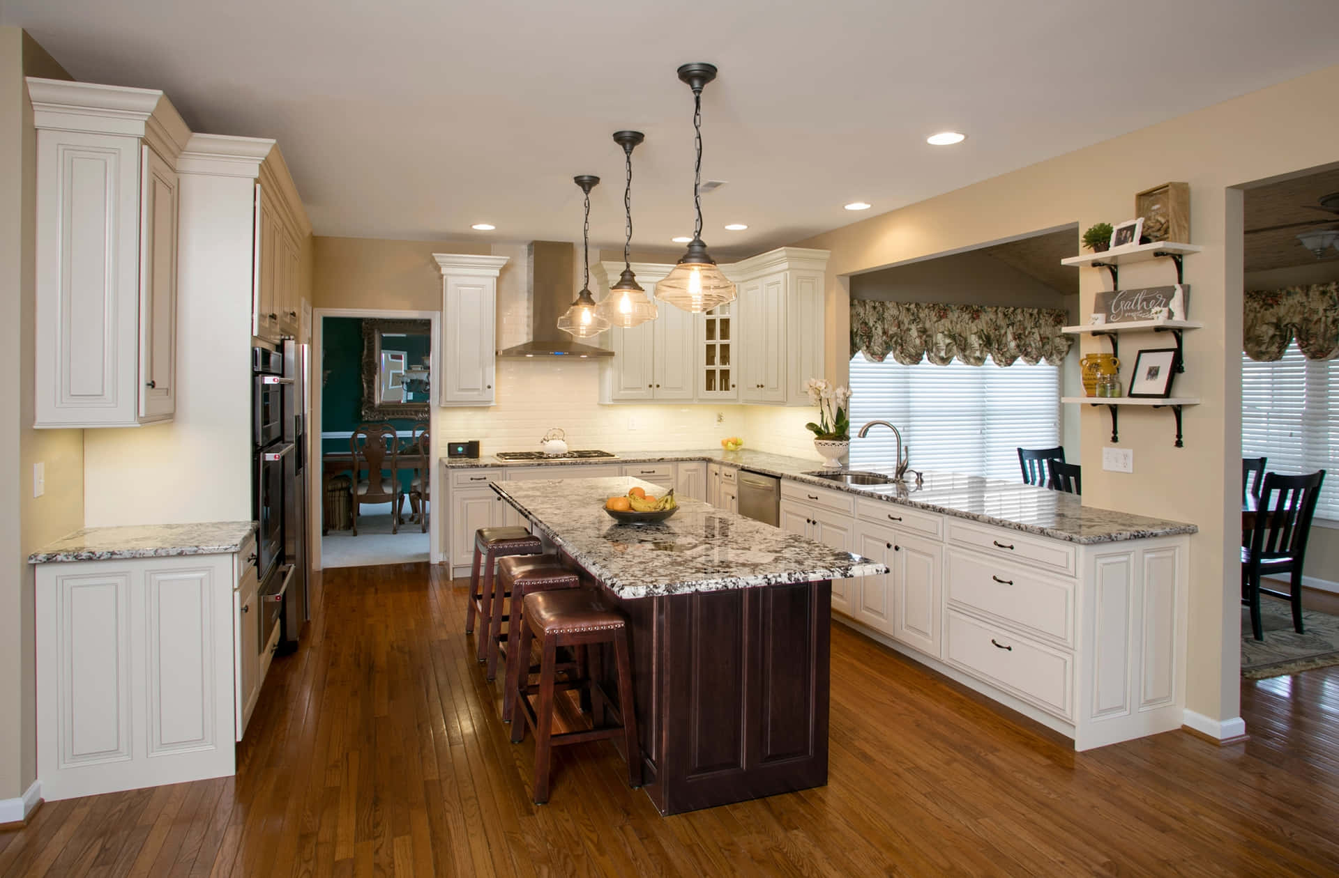 A Kitchen With A Center Island And Hardwood Floors
