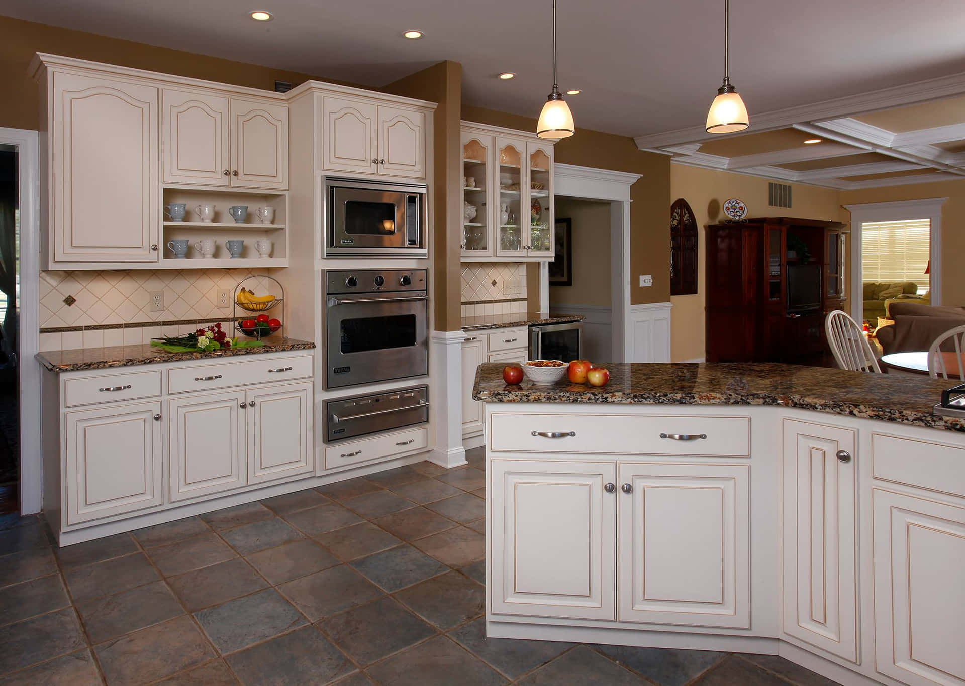 A Kitchen With White Cabinets And A Center Island