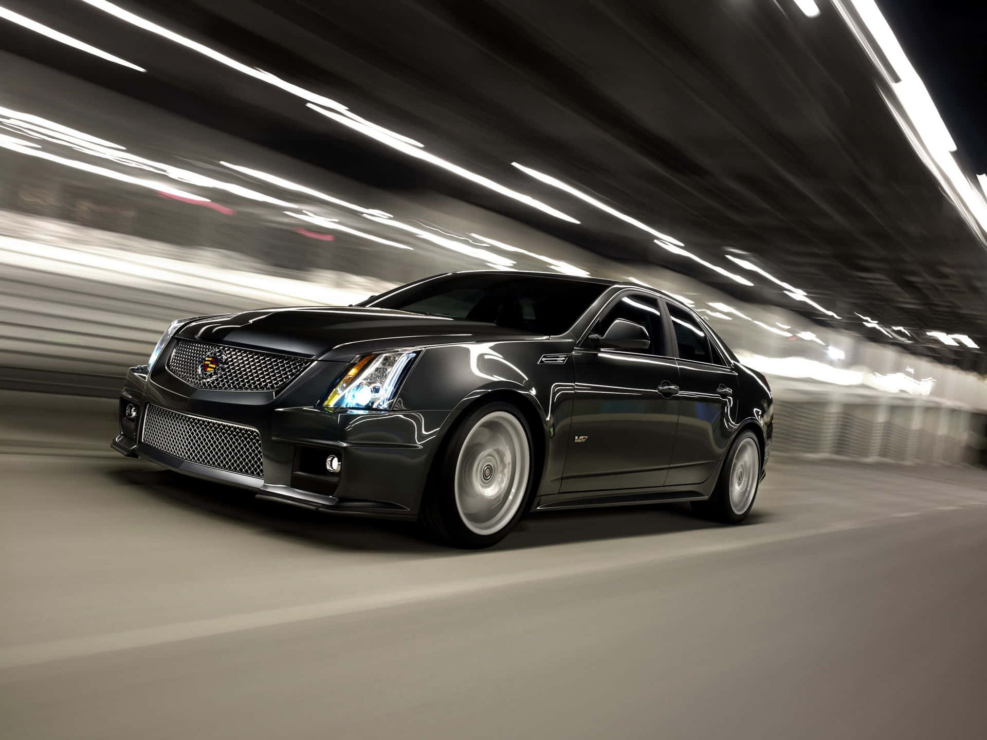 Luxurious Cadillac CTS gliding through the city streets Wallpaper