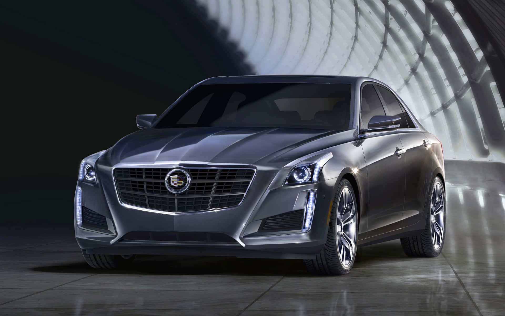 Stunning Cadillac CTS in a dazzling nighttime cityscape Wallpaper