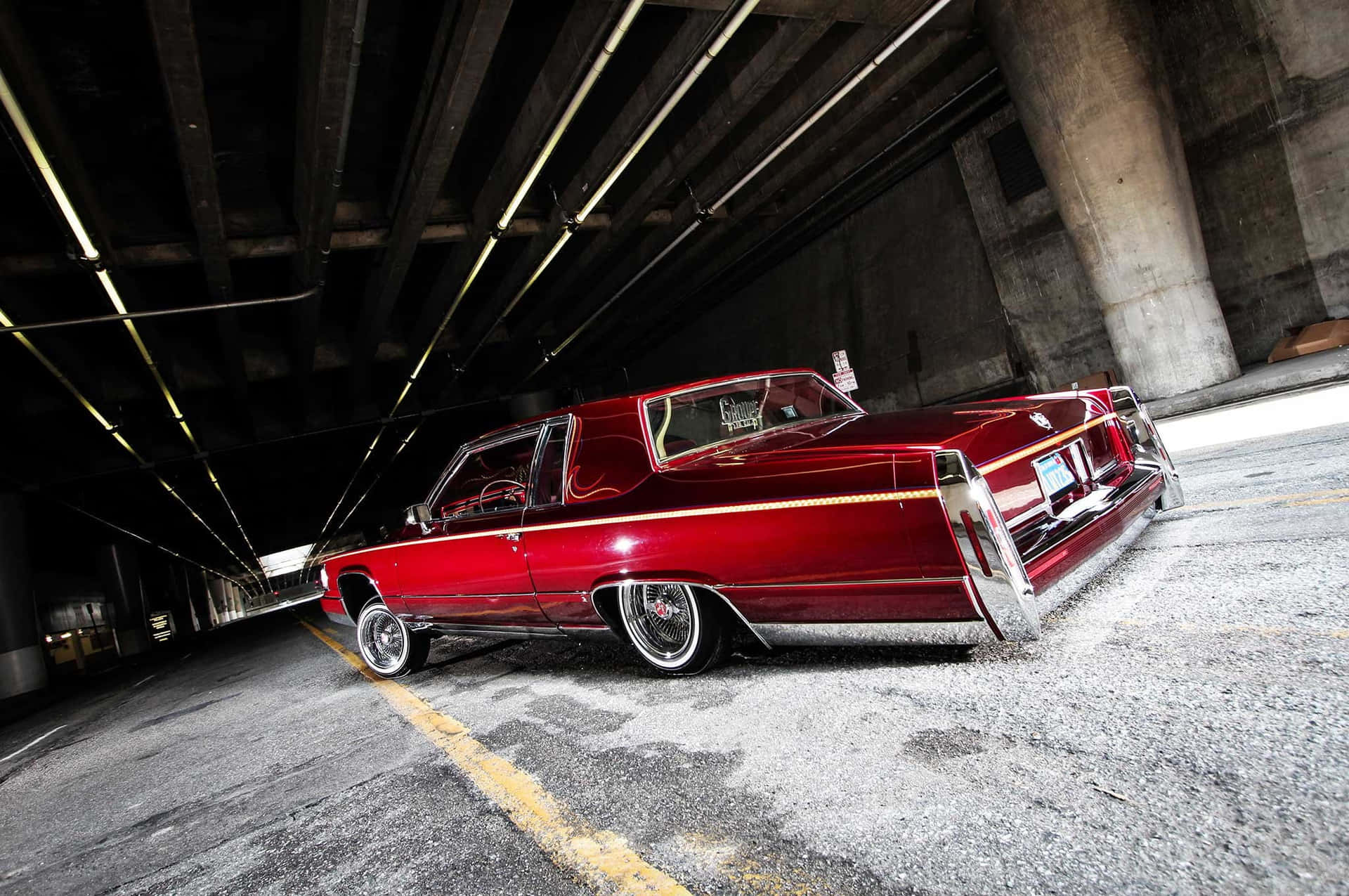 Sleek and Stylish Cadillac Deville Cruising the Road Wallpaper