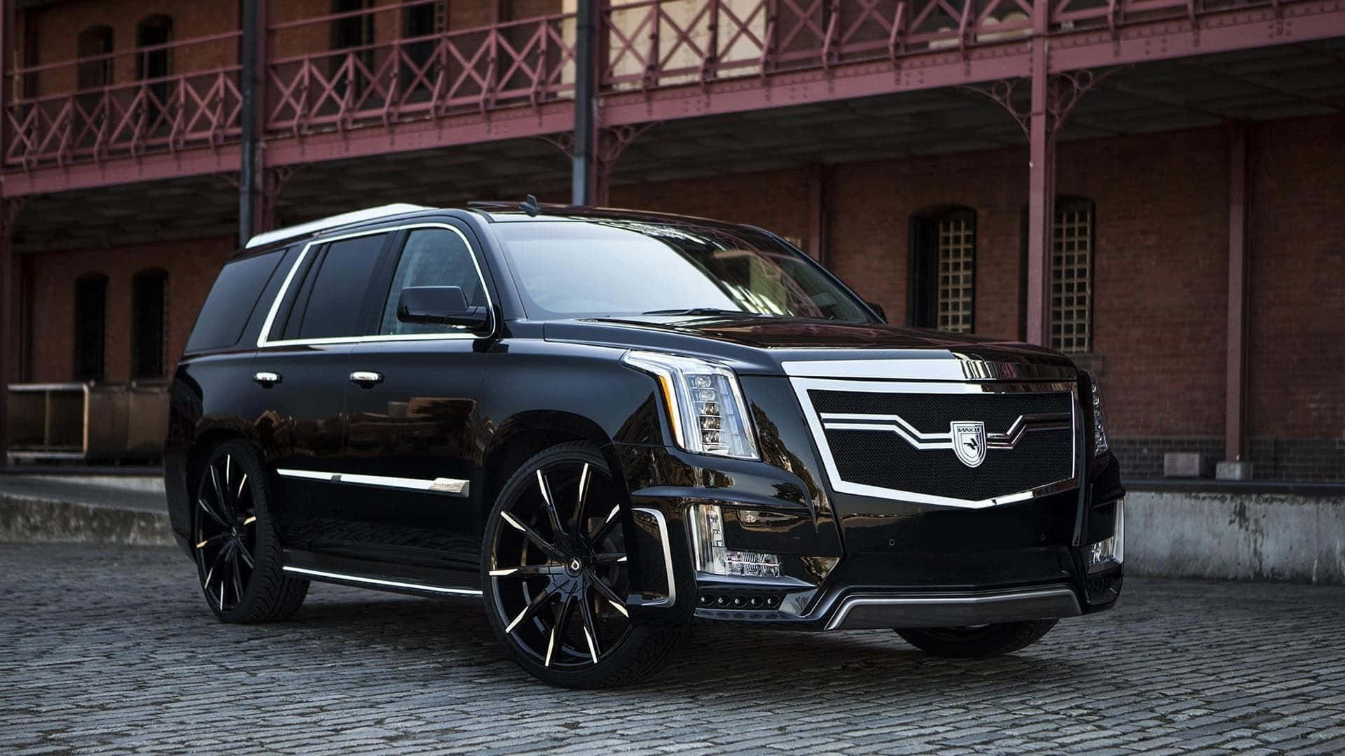 Stunning Cadillac Escalade in a Striking Urban Backdrop Wallpaper