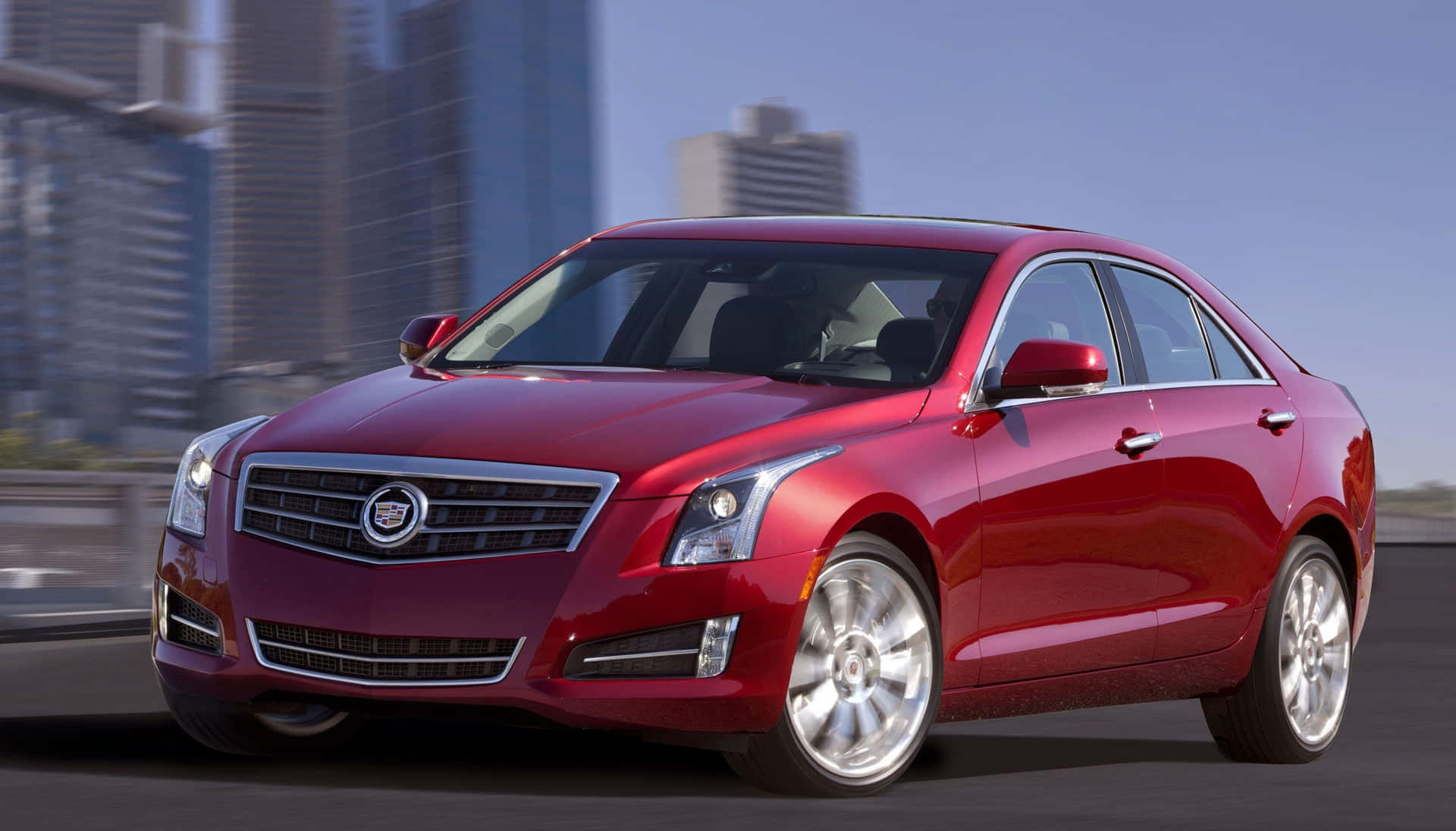 The Red Cadillac Ats Is Driving Down The Road