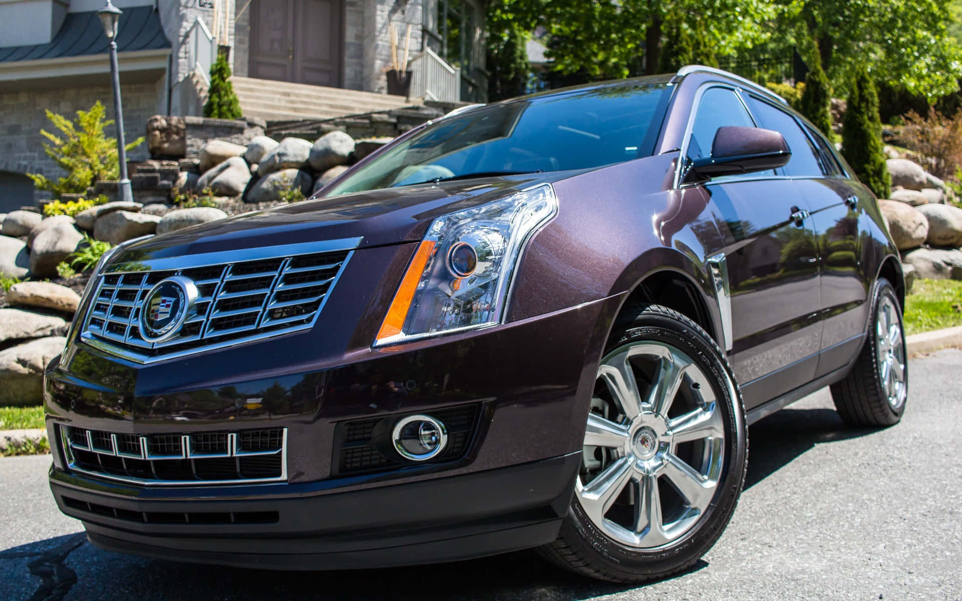 Luxurious Cadillac SRX driving on scenic highway Wallpaper