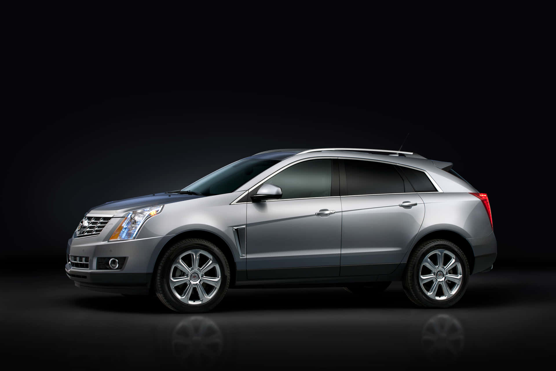 Sleek Cadillac SRX Driving on Scenic Route Wallpaper
