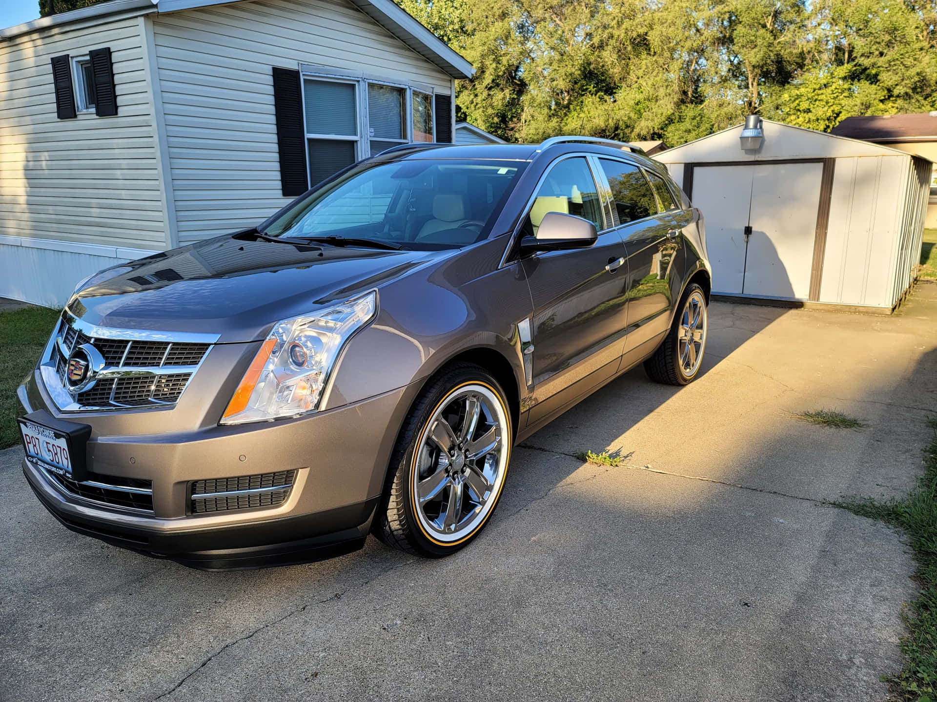 Caption: Sleek and Stylish Cadillac SRX on the Road Wallpaper